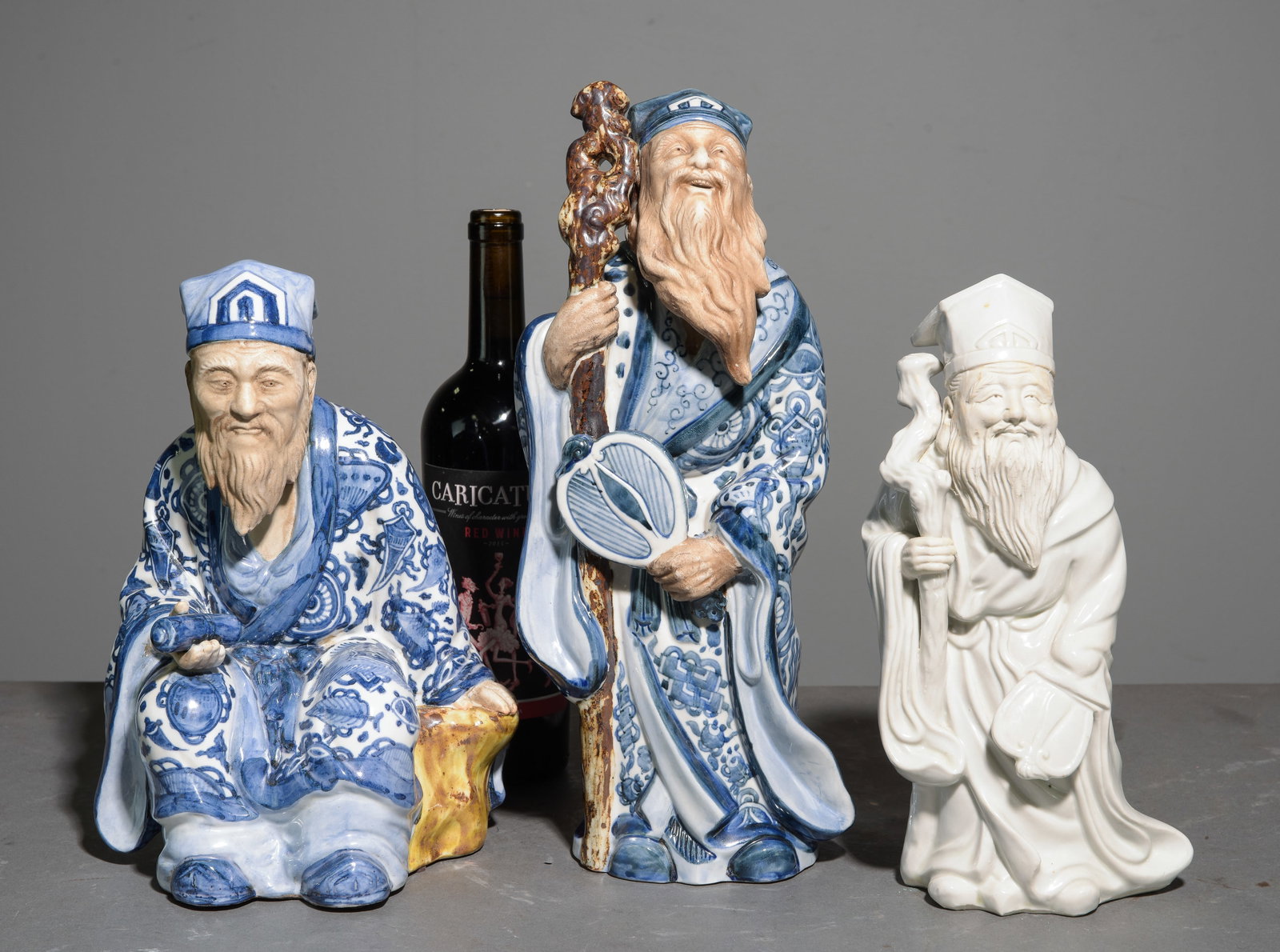 Three Japanese Kutani Statues of Jurojin: Three Japanese Kutani Statues of Jurojin - Two are stamped - Largest is 14.5 in tall x 6 x 5 Jurojin is the god of wisdom and longevity.