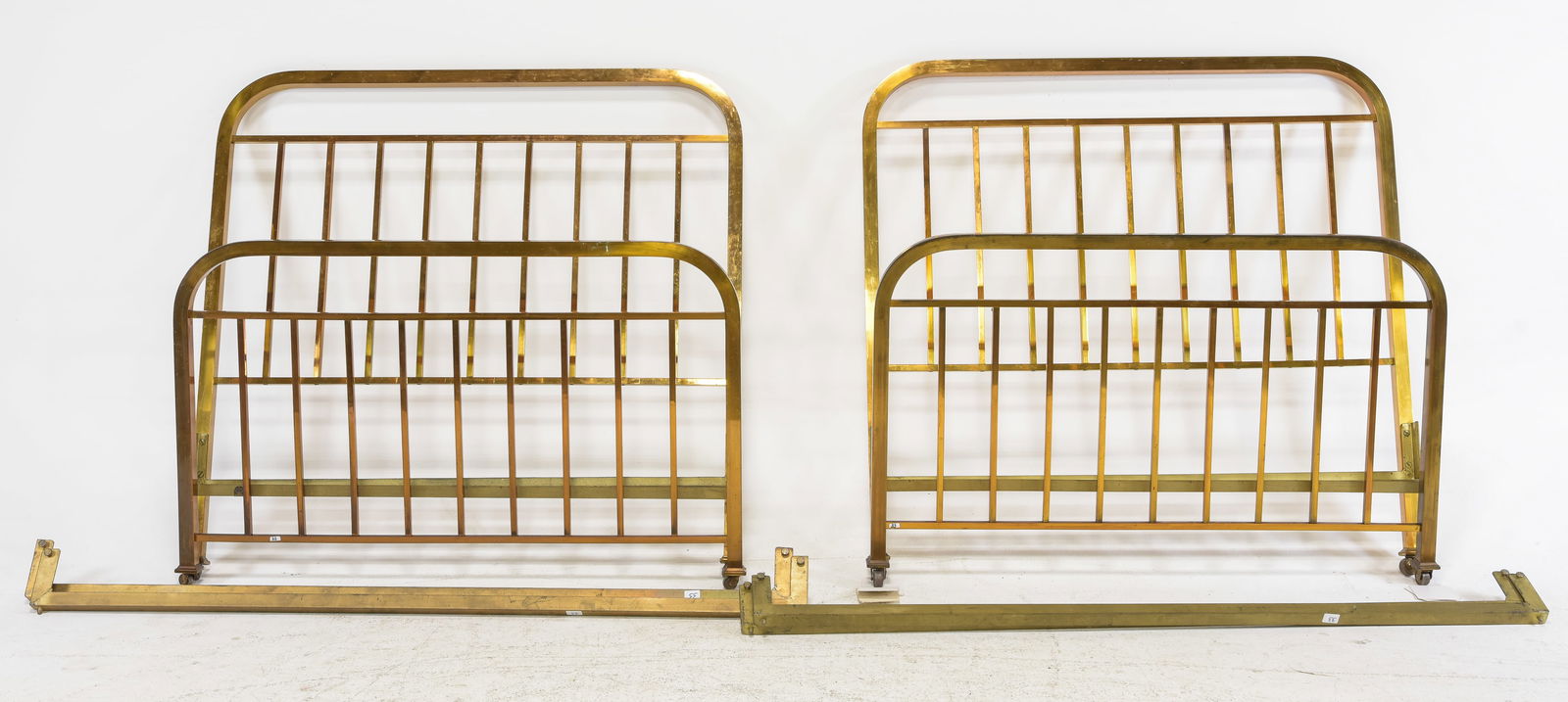 French Pair of Brass Finished Metal Beds: French Pair of Brass Finished Metal Beds with Rails - Headboards are 55.5 in tall x 56 x 2 each, Rails are 76 inches long each - This bed is a European size which can usually be converted to an Americ