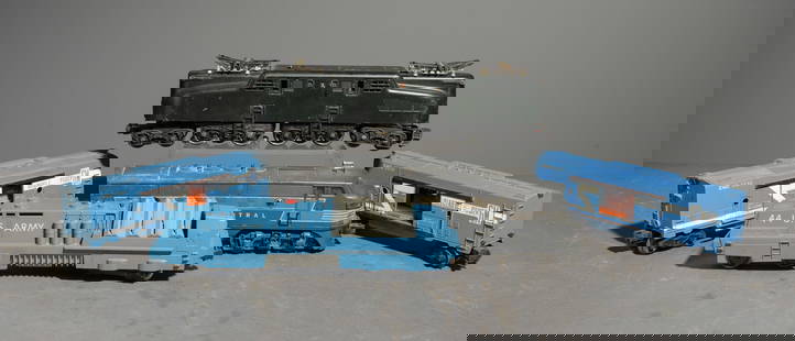 5pcs - Assorted Lionel Locomotives & Cars: This lot consists of (1) 2344 New York Central F3 AA Locomotive, (1) 2332 Pennsylvania GG1 Electric Locomotive, 44 US Army Mobile Missile Launcher Car, and (2) 3530 Electro Mobile Power Box Cars . Thi