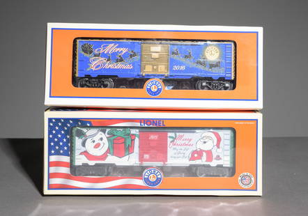 Lionel Christmas Boxcars: This lot consists of (1) 2015 Lionel Christmas Boxcar No. 6-82691 featuring die-cast metal sprung trucks and operating couplers in original packaging and (1) 2016 Lionel Christmas Boxcar No. 6-82954 f
