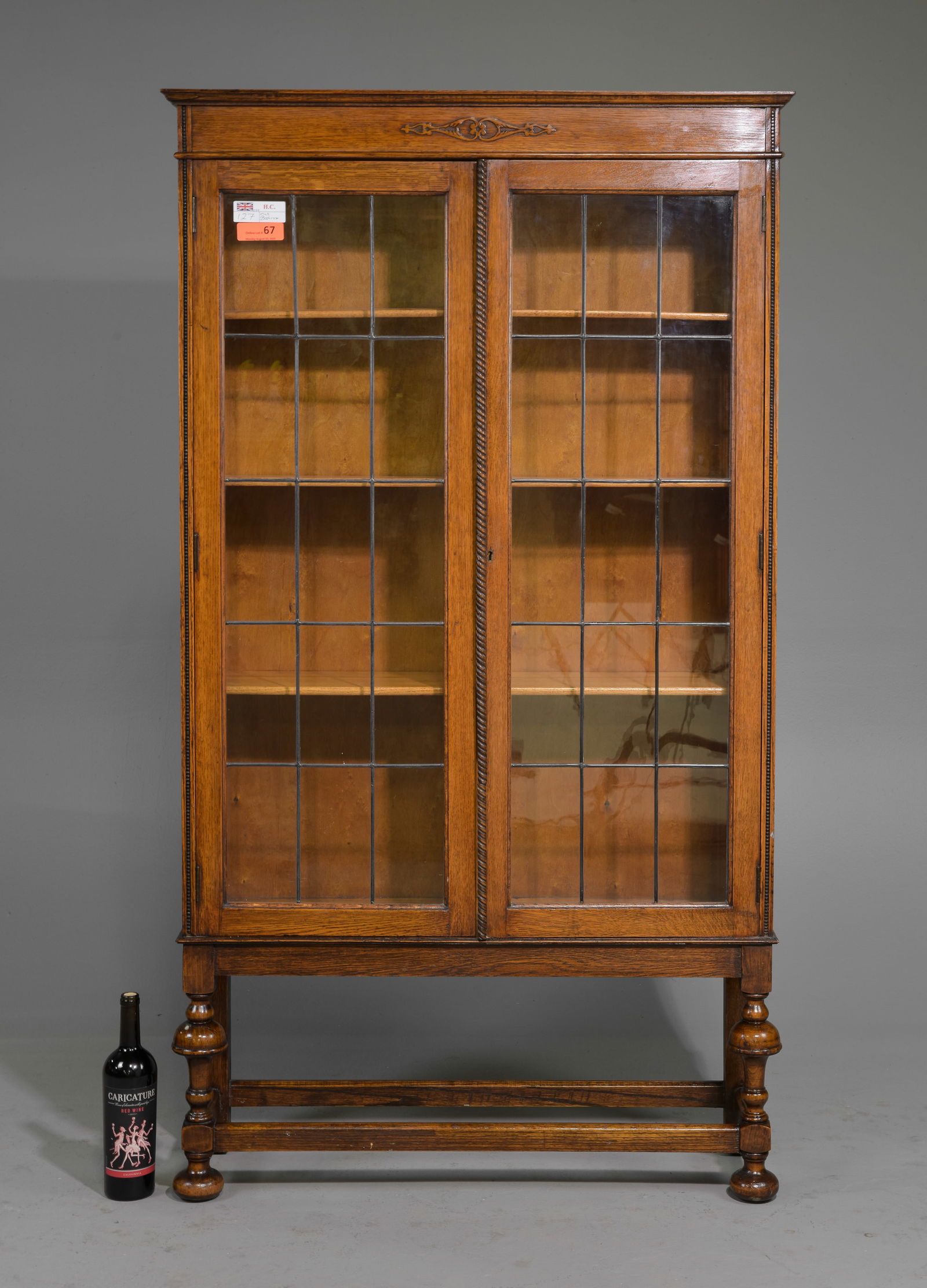 British Oak Leaded Glass Bookcase c.1930's: British Oak Leaded Glass Bookcase c.1930's - 64.5 in tall x 36 x 11.5 - The shelves are adjustable and the measurements of the shelves are 7.5 inches deep by 32.5 inches wide