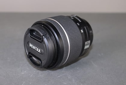 18-55mm Pentax lens, inside of brown leather Nikon case