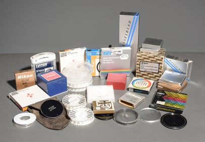 Assorted camera filter, lens, part boxes, lens caps, filter cases, etc.