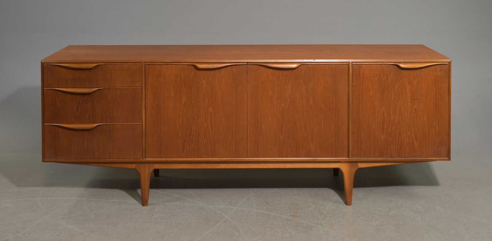 Mid Century Sideboard - Mcintosh - "Dunvegan": This Danish Modern Style Teak Credenza / Cocktail Sideboard with folded handles & pull out tray is made by Scottish Mid Century Modern Furniture Maker McIntosh. It was designed by Tom Robertson, it is