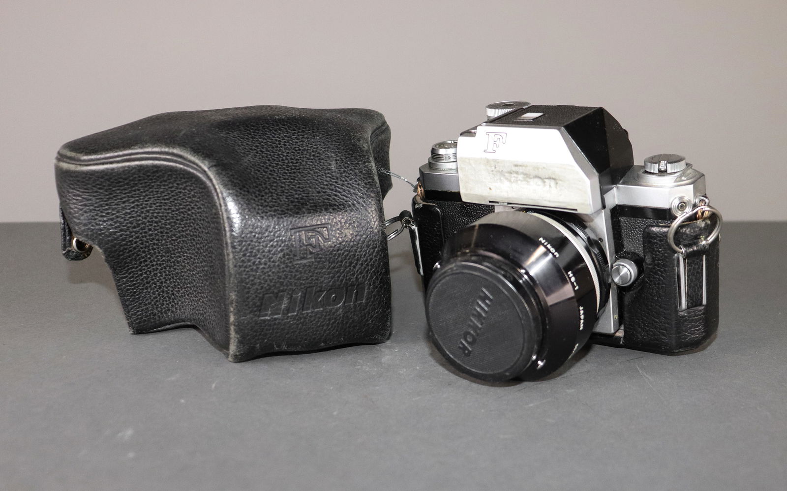 Nikon F Camera with S Auto Lens 1:1.4 50mm Nippon Kogaku - Nameplate & Lens Brand is Rubbed: Item: Nikon F Camera with S Auto Lens 1:1.4 50mm Nippon Kogaku - Nameplate & Lens Brand is Rubbed Off/Blacked Out in Black Pebbled Leather CaseBrand: NikonModel/Serial Number: 6881005