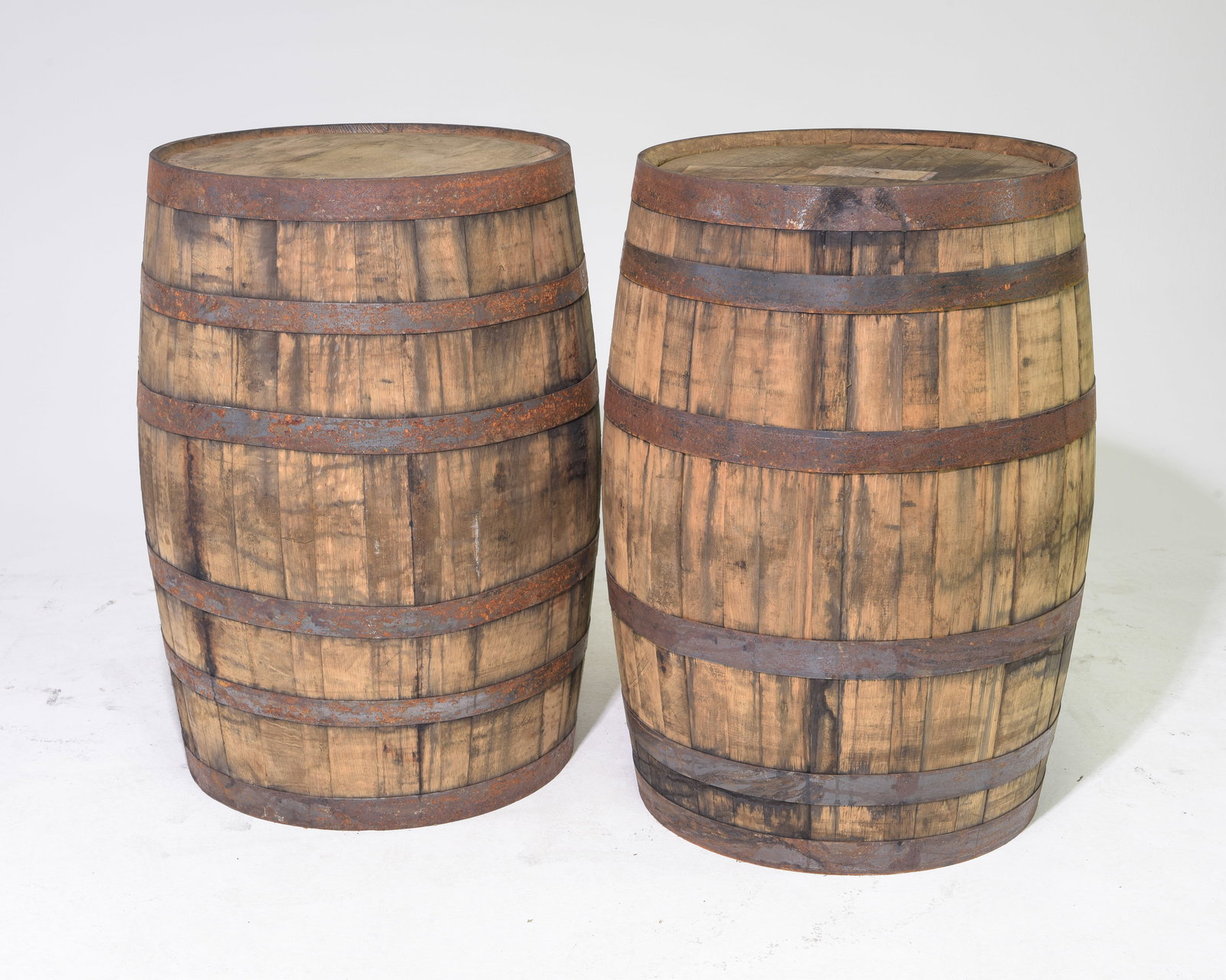 Two Rustic Iron Banded Barrels: Two Rustic Iron Banded Barrels - 35 in tall x 23 inch diameter