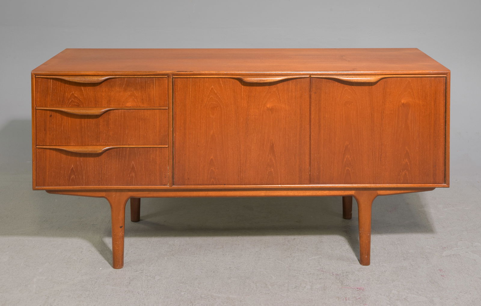 Mid Century Sideboard by McIntosh - "Dunvegan / Moy": This Danish Modern Style Teak Credenza / Cocktail Sideboard with folded handles is made by Scottish Mid Century Modern Furniture Maker McIntosh. It was designed by Tom Robertson, it is the Short "Dunv