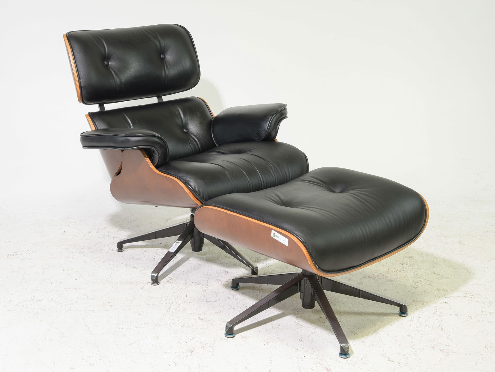 Mid Century Modern Eames Style Chair & Ottoman: Danish Modern Style Swivel Lounge Chair and Ottoman after Charles and Ray Eames / Herman Miller Model 670 / 671 - 34 in tall x 33 x 35 with a seat height of 18 inches, Stool is 17.5 in tall x 25 x 20.