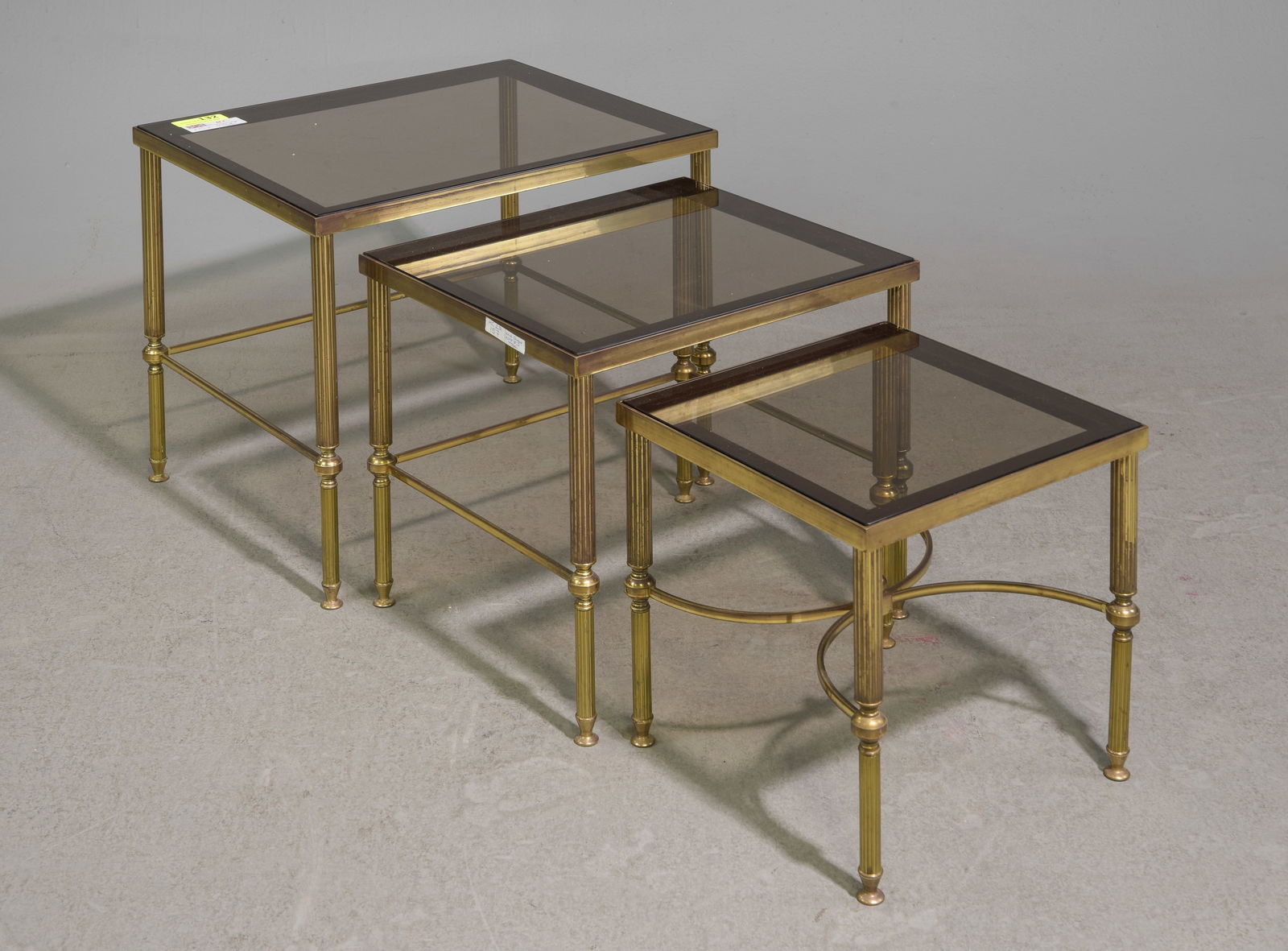 Brass Finished Nest of 3 Table with Smoke Glass: Brass Finished Nest of 3 Table with Smoke Glass - 18 in tall x 22 x 18, 16 in tall x 18 x 16 and 14 in tall x 14 x 14