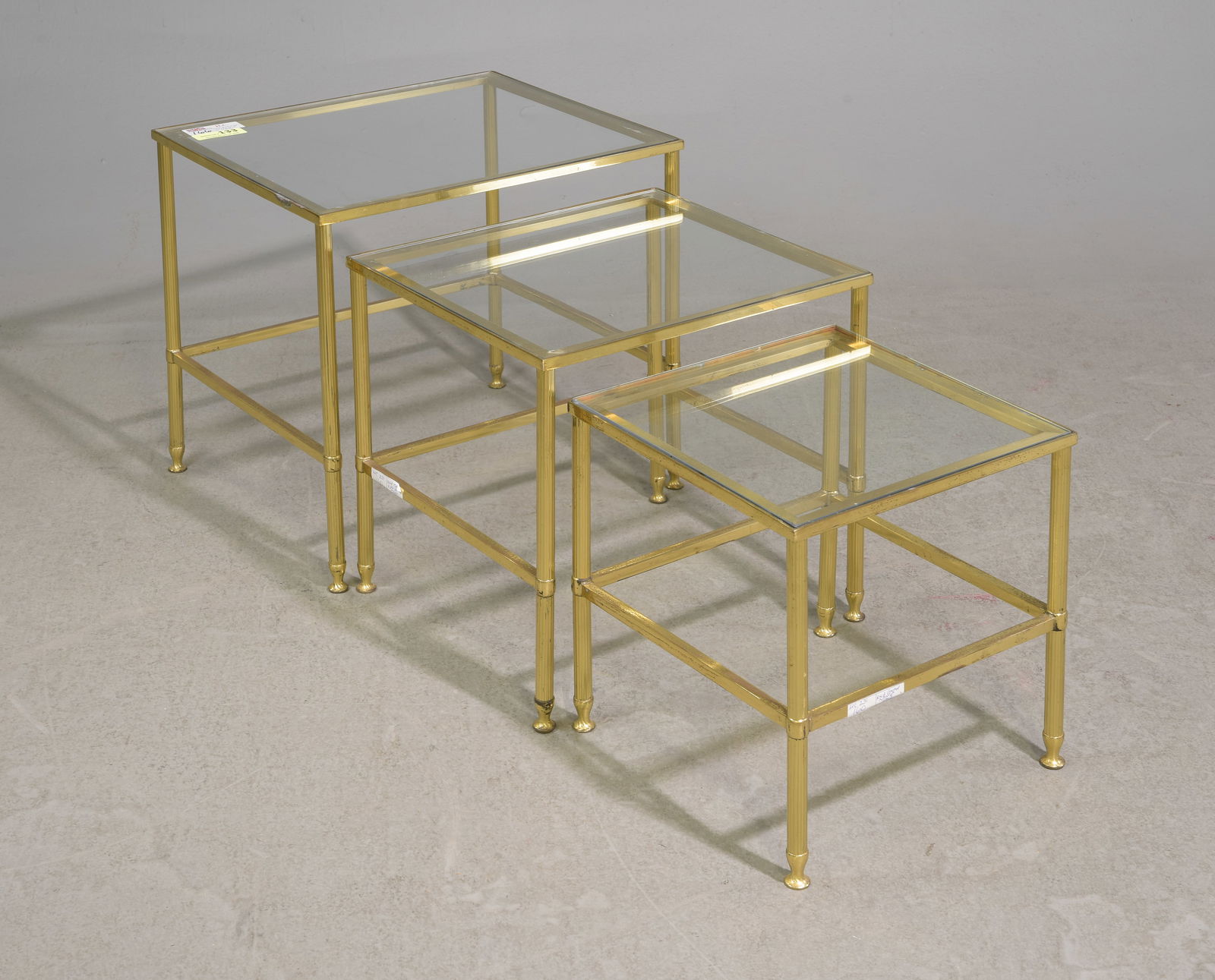 Brass Finished Nest of 3 Table with Glass: Brass Finished Nest of 3 Table with Glass - 18 in tall x 20.5 x 17.5, 16 in tall x 17.5 x 16 and 14 in tall x 14 x 14