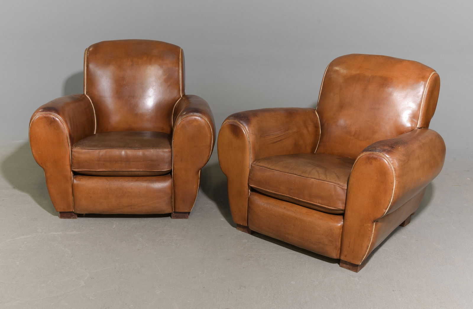 French Pair of Brown / Tan Leather Club Chairs: French Pair of Brown / Tan Leather Club Chairs - 31 in tall x 34 x 35, Seat height is 15.5 in