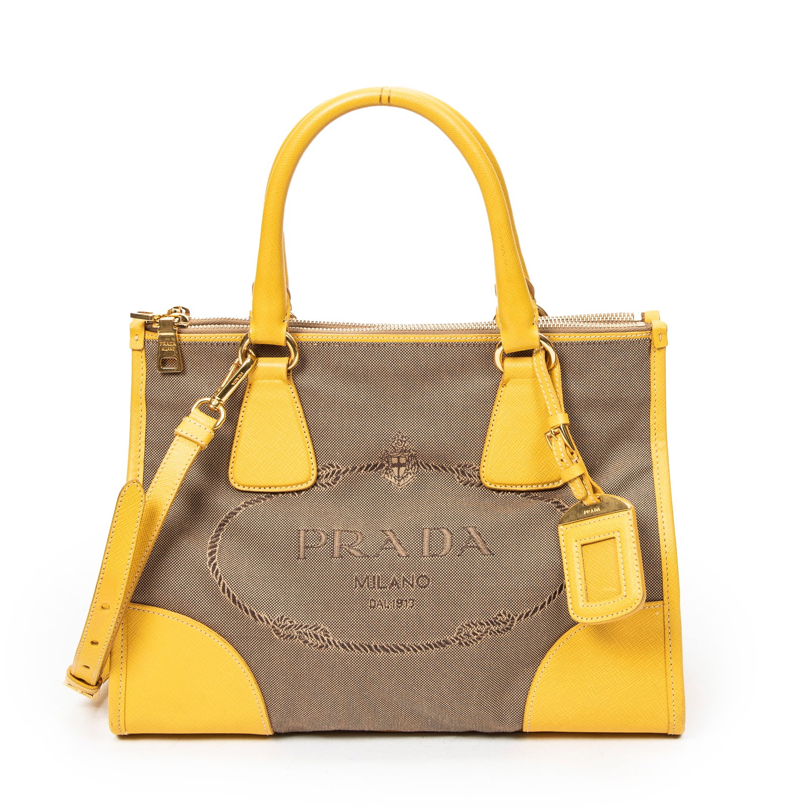 Prada Double Zip Jacquard Tote in Khaki/Yellow Canvas: Genuine Pre-Owned Prada Double Zip Jacquard Tote in Khaki/Yellow Jacquard Canvas made in Italy in A condition. Date Code is 197B Measurements: 31*23*13cm (Length * Height * Width). This lot includes a