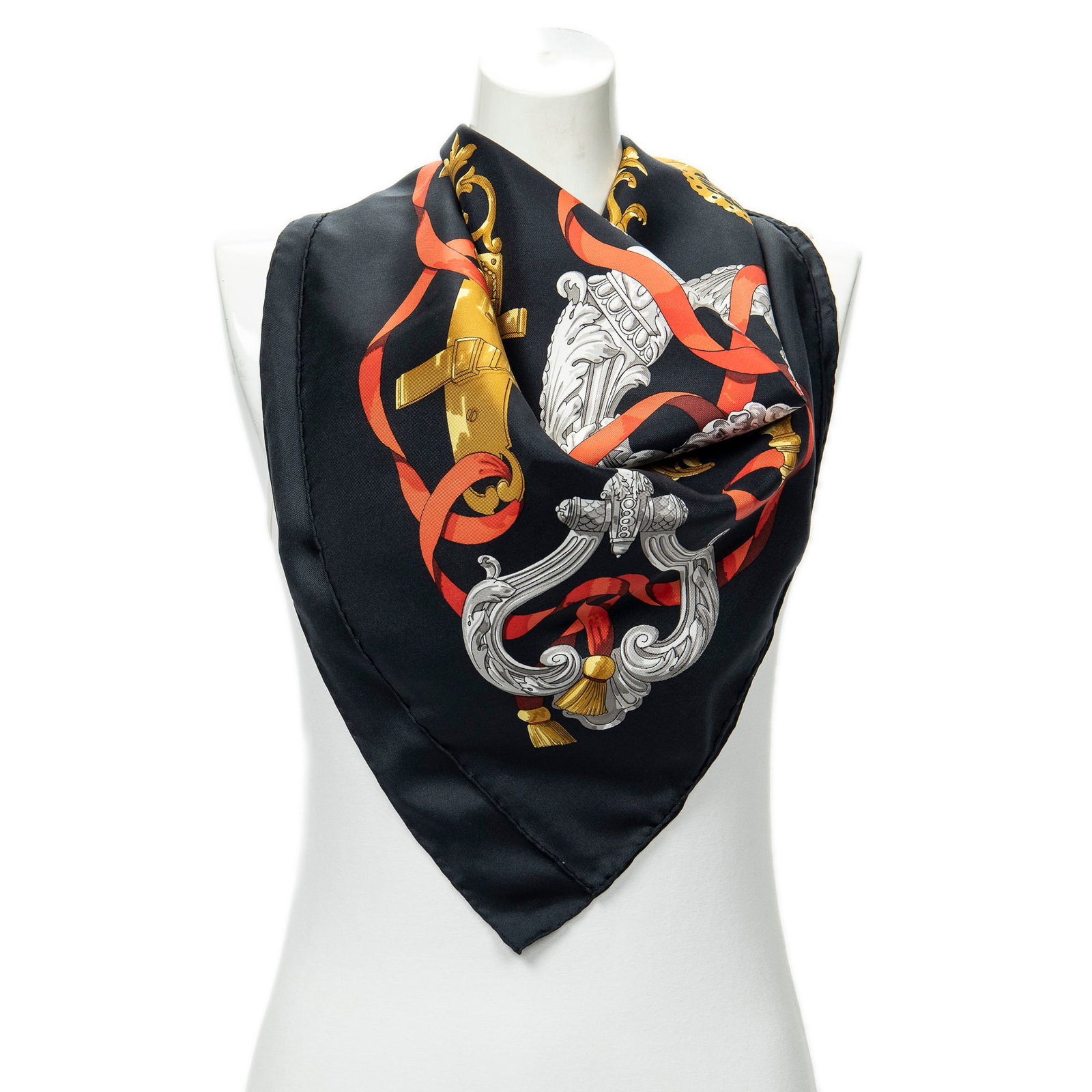 Hermes Scarf- Ferronnerie by Caty Latham: Genuine Pre-Owned Hermes Scarf in Black/Red/Gold 100% Twill Silk in AA condition. Pattern / Title is Ferronnerie by Caty Latham Measurements: 90*90*0cm (Length * Height * Width). This lot includes a c