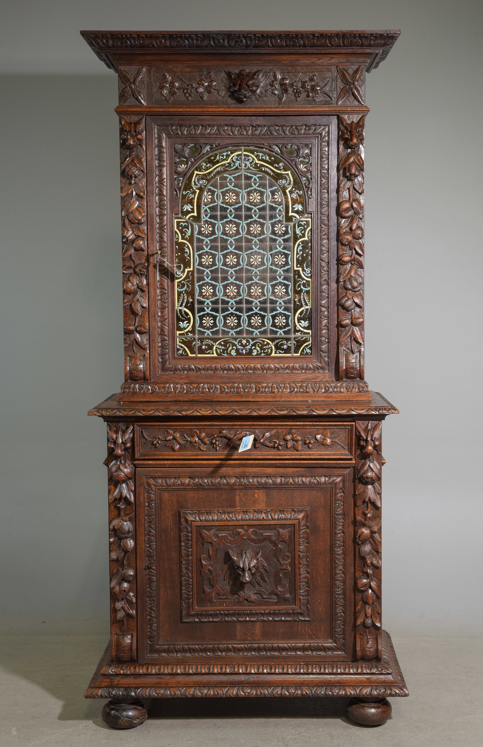 Renaissance Style Carved Oak Cupboard: French Renaissance Style Finely Carved Oak Cupboard c.1890's-1920's featuring a stunning leaded & enameled glass door - 84 in tall x 37.5 x 20.5