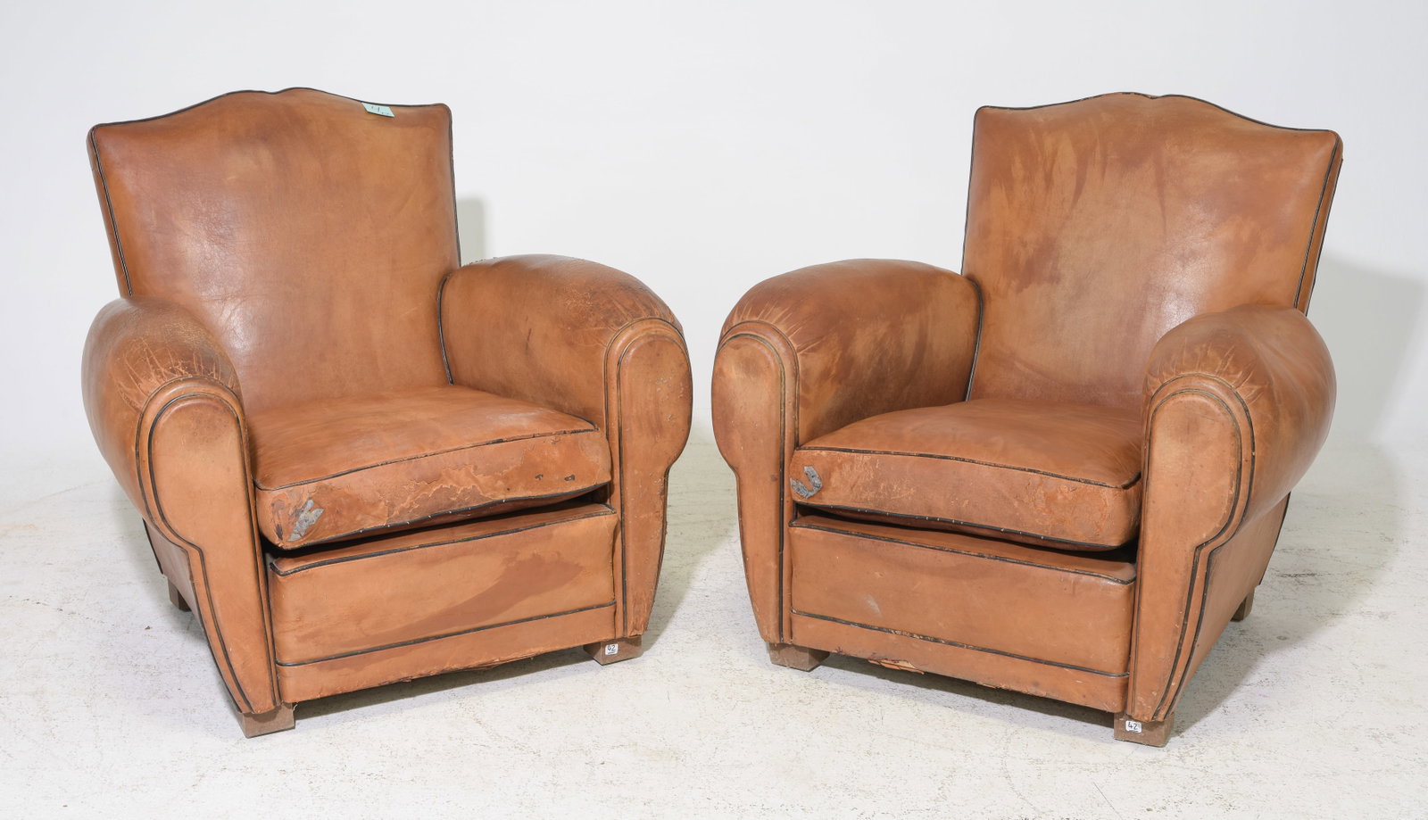 French Tan Leather Pair of Mustache Club Chairs: French Tan Leather Pair of Mustache Club Chairs - 33 in tall x 35 x 37 each with a seat height of 17 inches