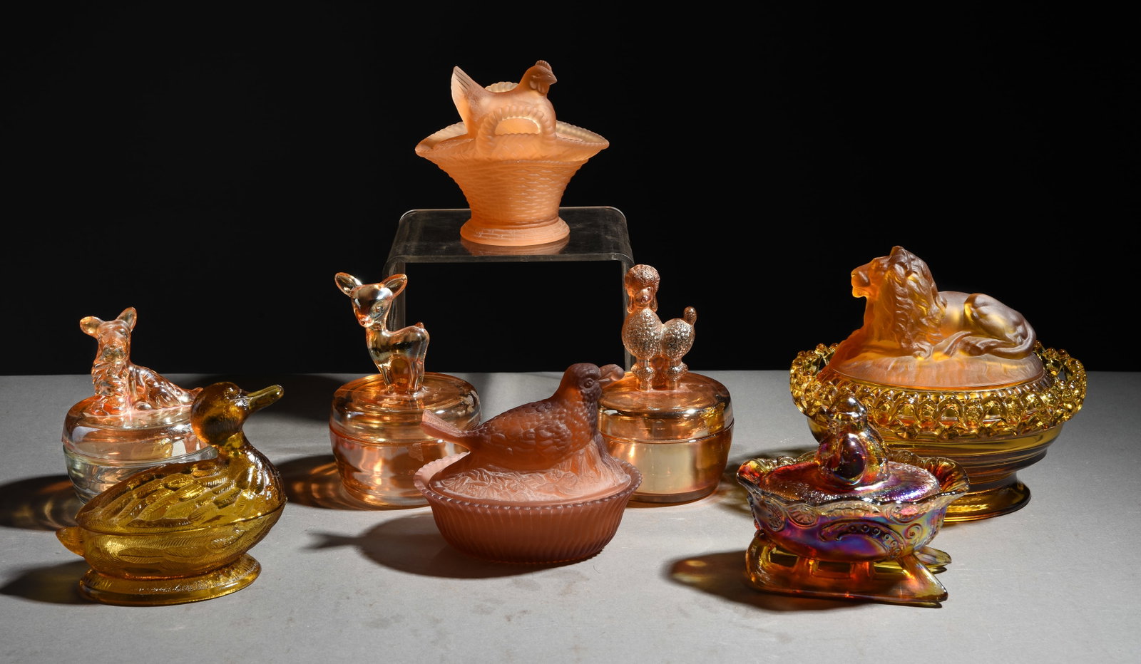 8 Imperial & Carnival Amber Glass Candy / Powder Dishes: 8 Imperial & Carnival Amber Glass Candy / Powder Dishes - Largest is 6.5 in tall x 7.5 x 6 - This lot features an Imperial Glass Amber Lion on Nest Candy Dish, a Westmorland iridescent carnival glass 