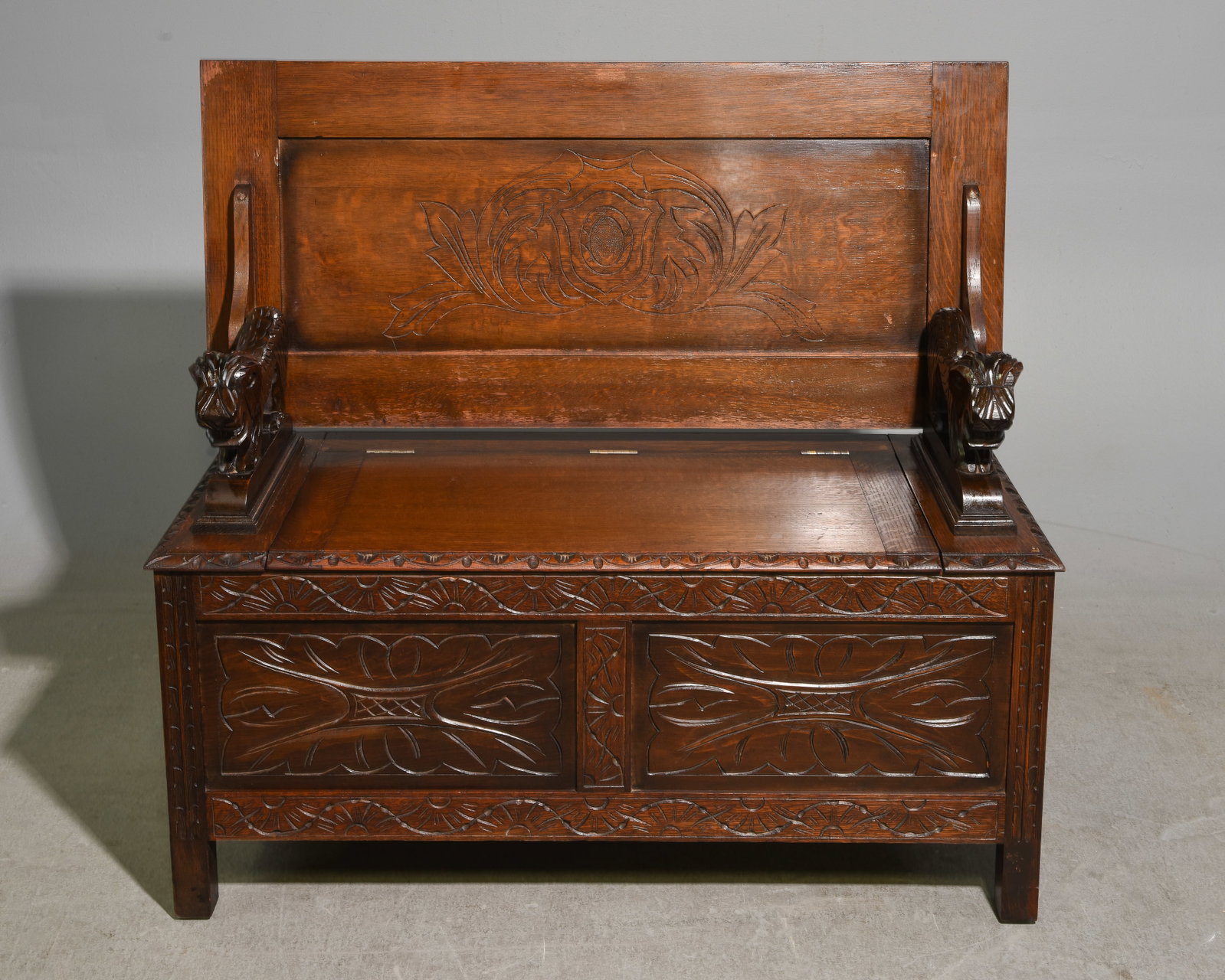 British Carved Oak Monks Bench with Lions: British Carved Oak Monks Bench with Lions - 28 in tall x 42.5 x 19, When used as a bench this is 39 in tall x 42.5 x 19 with a seat height of 18.5 inches