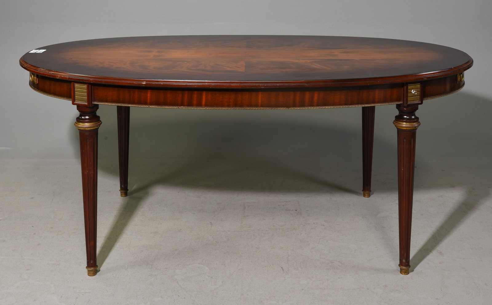Louis XVI Style Oval Mahogany Dining Table: French Louis XVI Style Oval Mahogany Dining Table - 30.25 in tall x 71.5 x 42, Floor to apron is 25.75 inches and the space between the legs is 42.5 inches