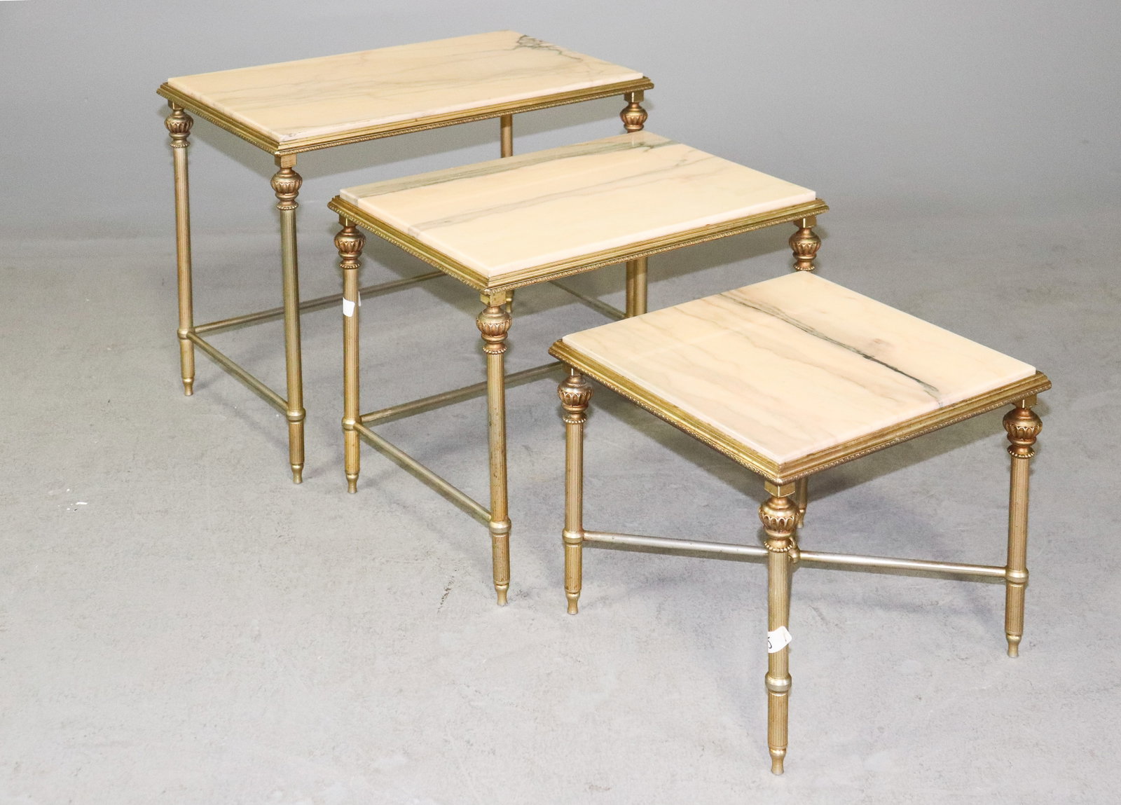Louis XVI style brass and marble nesting gigogne tables: French Louis XVI style brass and marble nesting gigogne/nest of 3 tables. Table heights 17.5 in tall x 22.5 in x 14 in, 14.5 in tall x 18.75 in x 14 in, and 12 in tall x 14 in x 14 in.