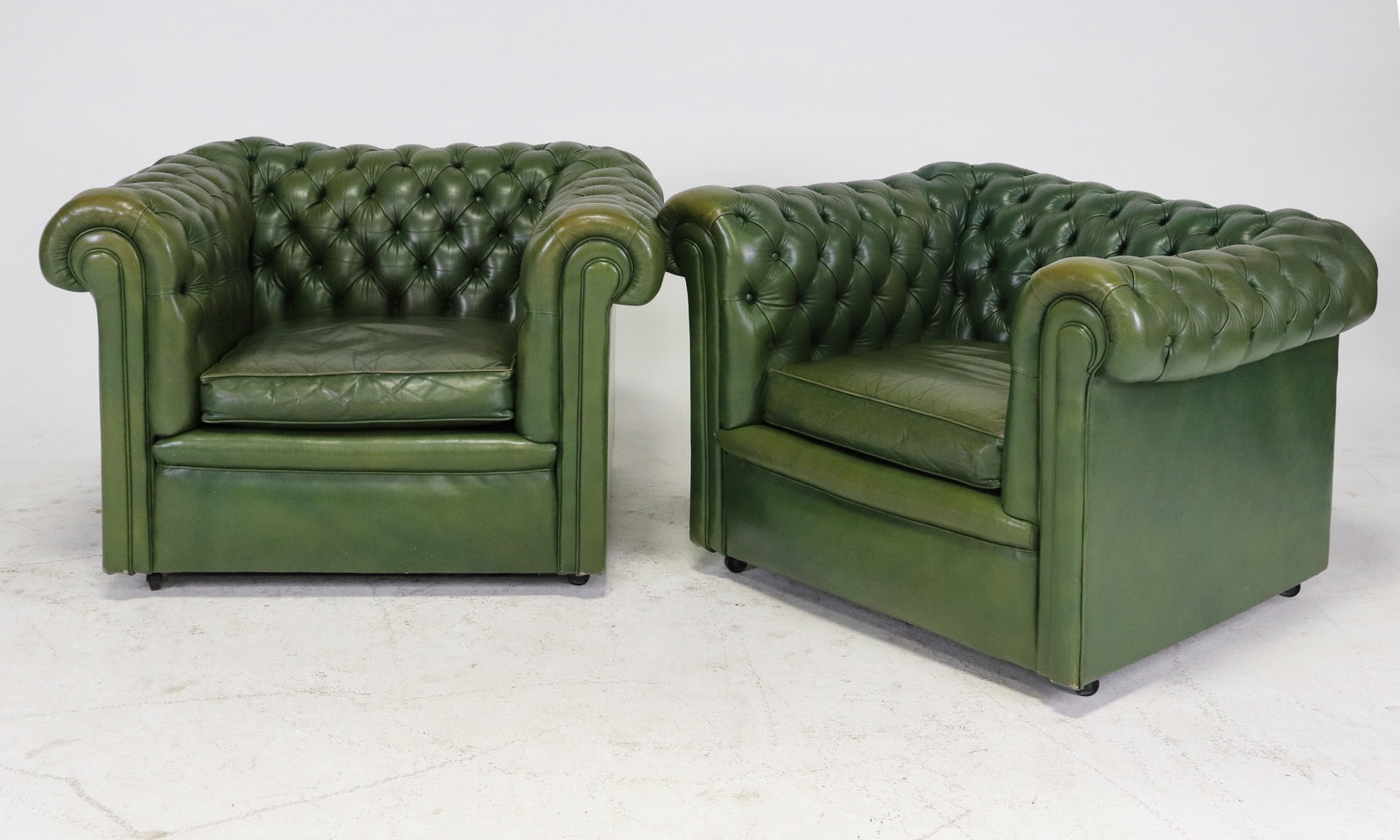 British Chesterfield Roll Top Button Tufted Arm Chairs: Pair of Green British Chesterfield Roll Top Button Tufted Arm Chairs 25.5 in tall x 41.5 in x 35 in with seat height 16 in tall.