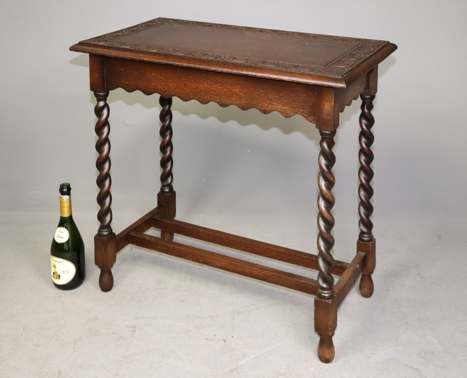 British Oak Etched Barley Twist Table: British Oak etched/carved top barley twist table that is 28.75 in tall x 30 in x 17 in.