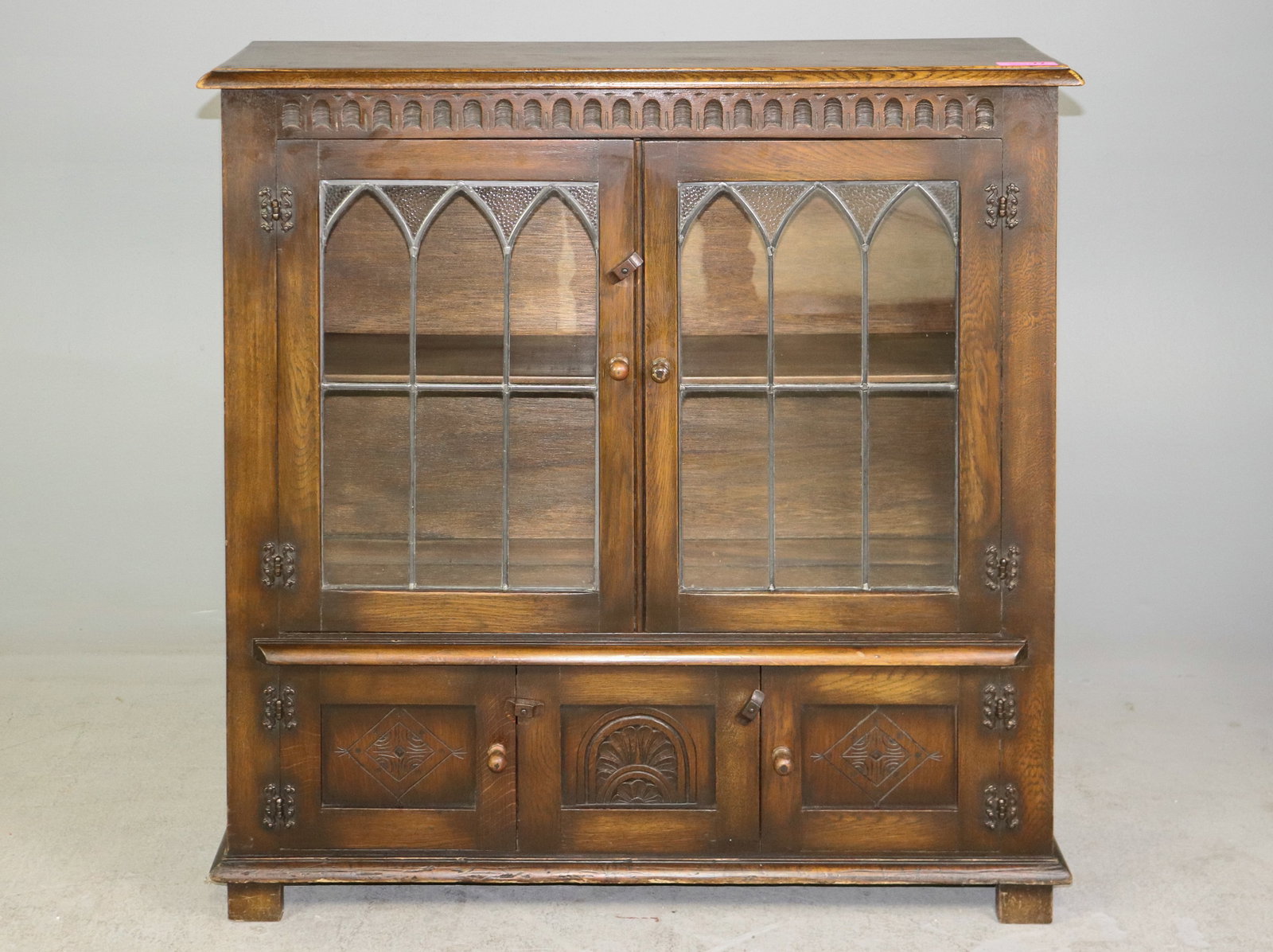 British Oak Leaded Glass Bookcase: British Oak Leaded Glass Bookcase that is 41 in tall x 40 in x 11.5 in.