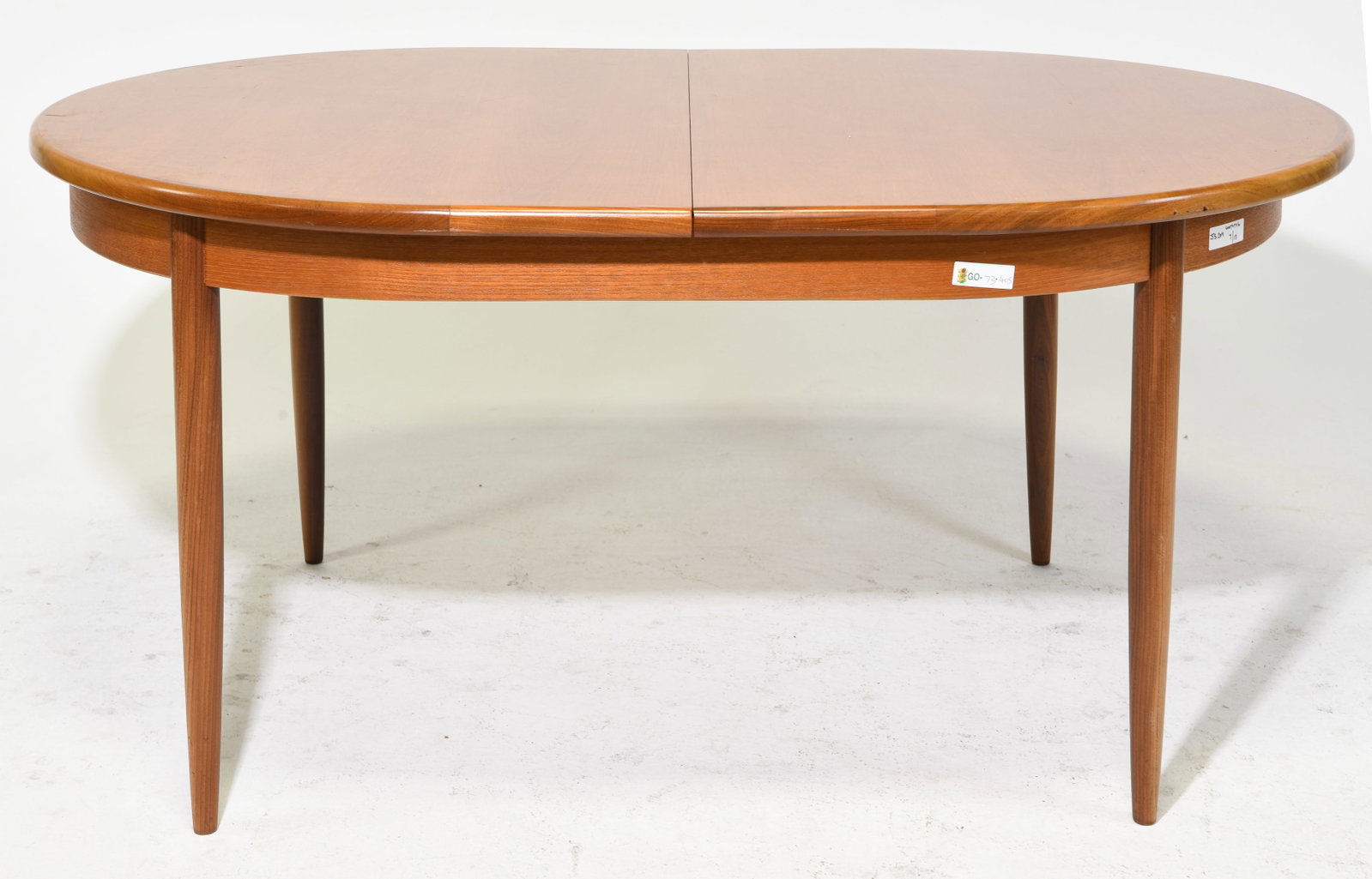 Mid Century Oval Dining Table by G-Plan: This Danish Modern Style Oval dining table with four leg base is made by Mid Century Modern Furniture Maker G Plan ( Gplan ), it has a pop out leaf . - 29 in tall x 64 x 44, Leaf adds an additional 18