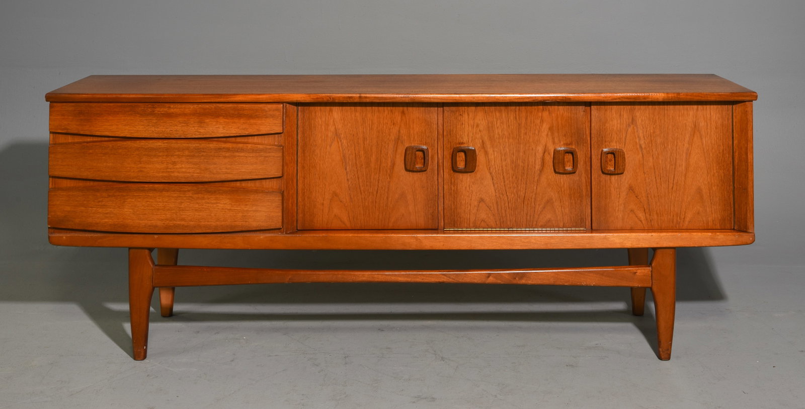 Mid Century Modern Sideboard with Open Stretcher: Danish Modern Style Sideboard with Open Stretcher Base, Drop Front Door and Three Drawers - 31.75 in tall x 84 x 17