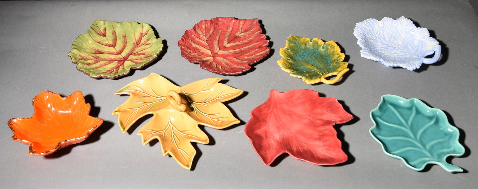 8 Assorted Pottery Leaf Trays / Dishes: 8 Assorted Pottery Leaf Trays / Dishes - Largest is 3 in tall x 11 x 9.5 - Some is marked made in U.S.A, some China, Etc.