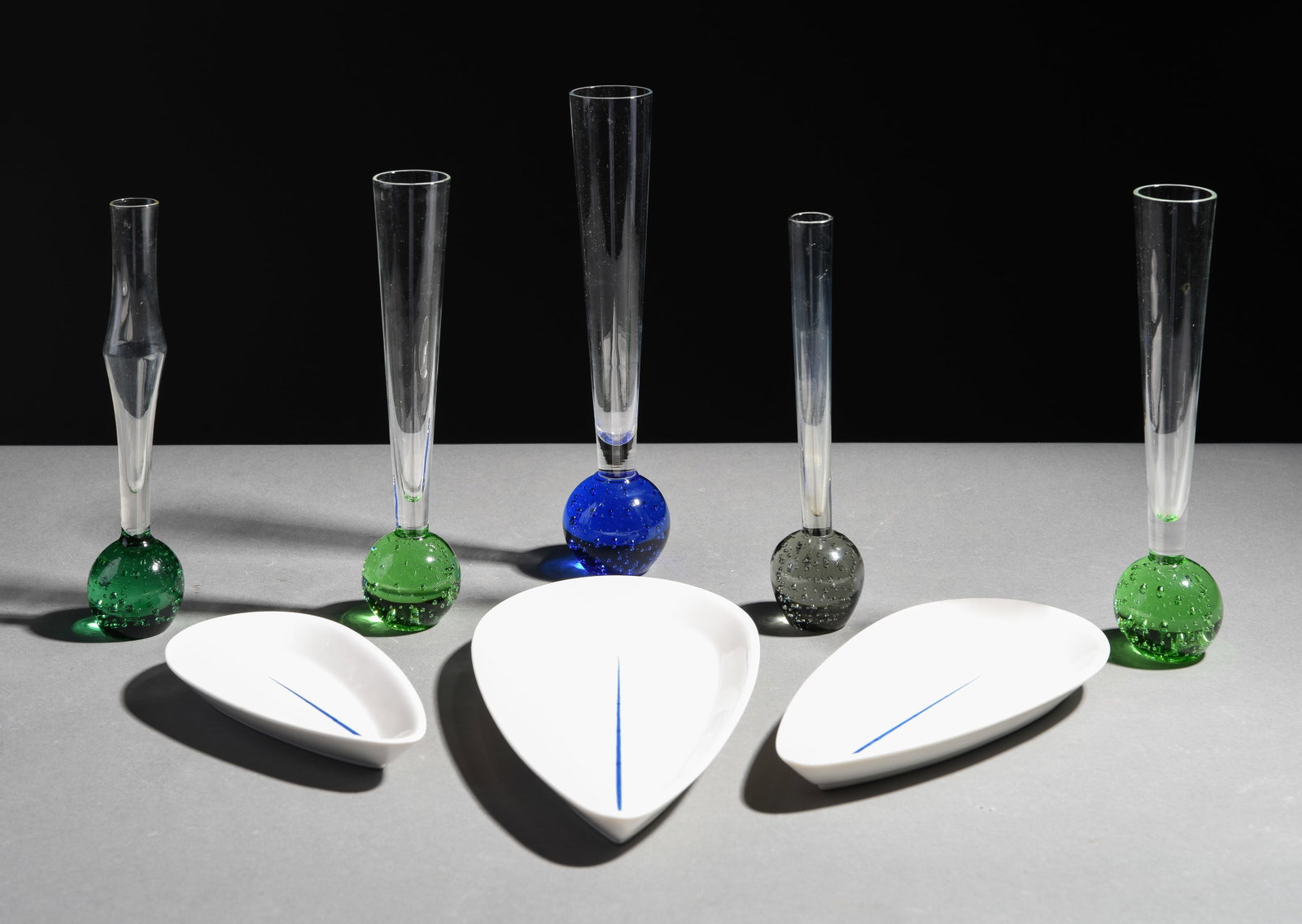 8pcs - 5 Art Glass Bud Vases & Three Trays: 8pcs - 5 Art Glass Bud Vases & Three Ceramic Trays designed by Hwang Yong Sik - Tallest pieces is 10 in tall x 2.5 inch diameter at the base
