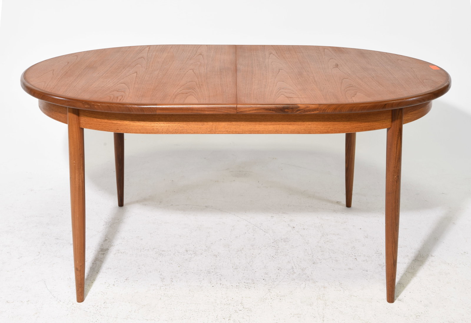 Mid Century Oval Dining Table by G-Plan: This Danish Modern Style Oval dining table with four leg base is made by Mid Century Modern Furniture Maker G Plan ( Gplan ), it has a pop out leaf . - 29 in tall x 64 x 44, Leaf adds an additional 18