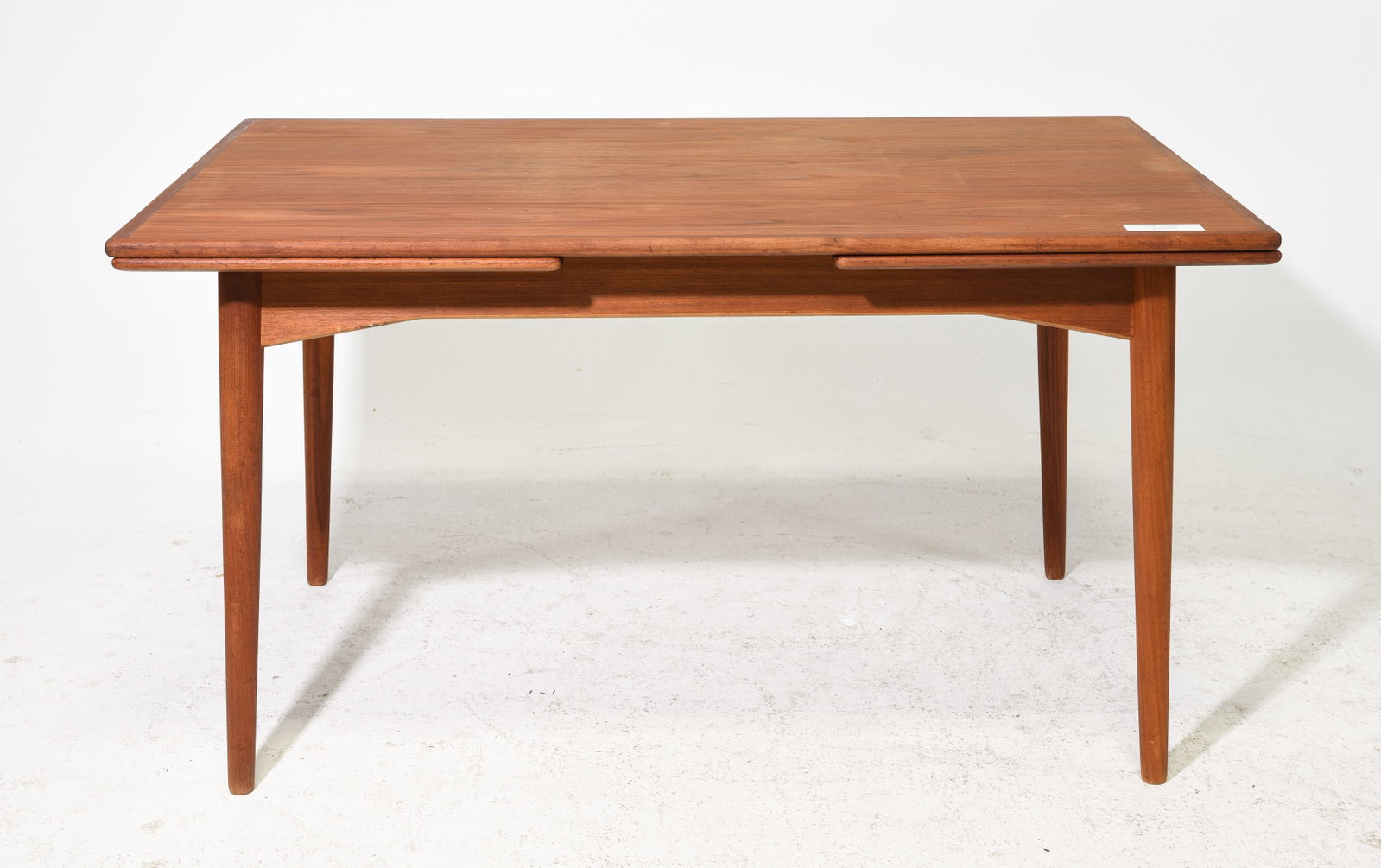 Danish Modern Teak Draw Leaf Table: Danish Modern Teak Draw Leaf Table - 29 in tall x 53.5 x 34.5, Leaves add an additional 20.25 each, Floor to apron is 23.75 inches and the space between the legs is 43.5 inches