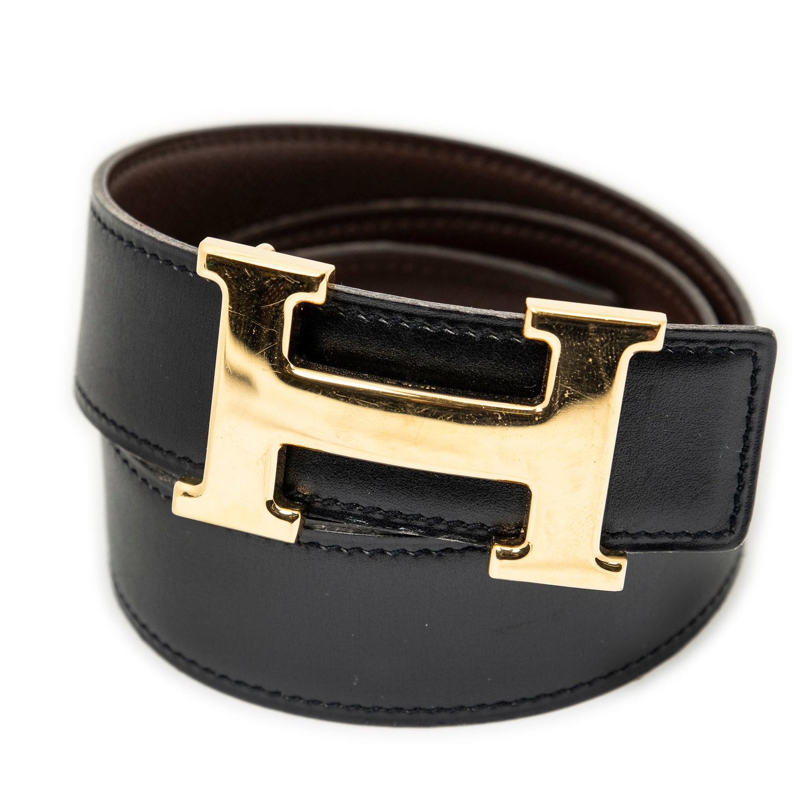 Hermes Constance H Belt 65 in Box Leather: Genuine Pre-Owned Hermes Constance H Belt 65 in Black/Dark Brown Box Leather in A condition. Date Code is Stamp B in Square (1998) This lot includes the following accessories: None. Measurements: Size