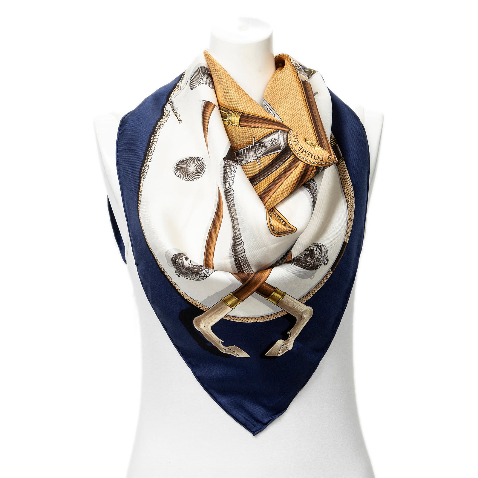Hermes Scarf- Cannes & Pommeaux by De La Perriere: Genuine Pre-Owned Hermes Scarf in Navy/Brown/Ivory 100% Twill Silk in AA condition. Pattern / Title is Cannes & Pommeaux by Fran?oise De La Perriere Measurements: 90*90cm (Length * Height * Width). Th