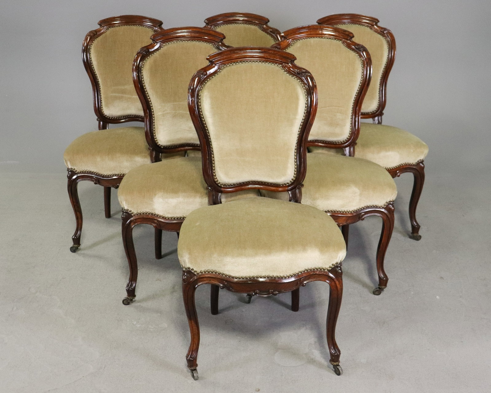 Set of 6 Victorian Louis XV Revival Walnut Dining Chairs: Handsome set of six antique Victorian Louis XV Revival dining or parlor chairs featuring richly carved walnut frames with shaped upholstered backs and generously proportioned seats. Each chair is deta