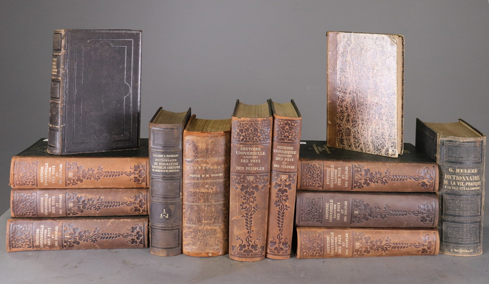 Collection of 13 Early 20th Century French Leather Bound Books: collection of early 20th century French books with decorative leather and gilt bindings, including examples dated 1913. Various titles and subjects. Sold for decorative purpose. Largest is 10.25 x 7.2