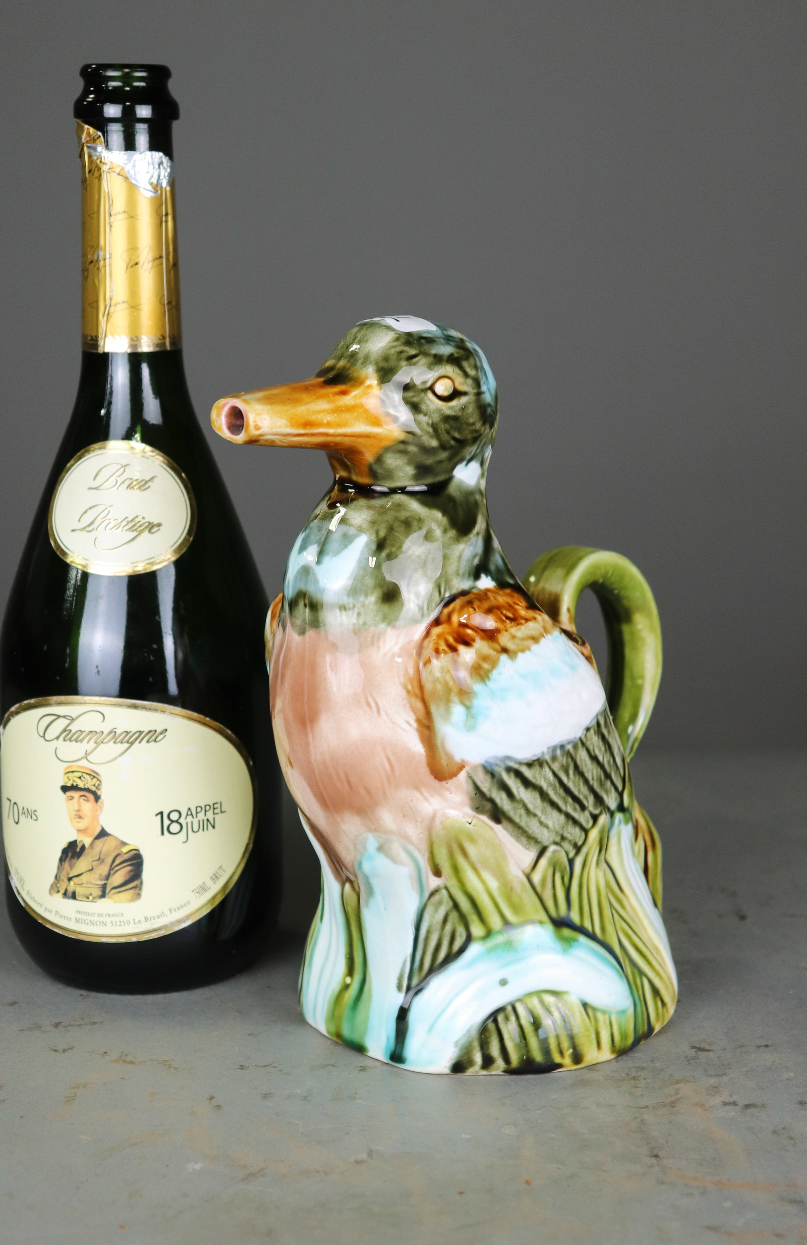 French Majolica Figural Duck Pitcher: Colorful French majolica pitcher modeled as a duck among reeds, with a curved handle and richly glazed figural decoration. Maker and age unknown. - 9.5 in in x 8.5 x 4.5