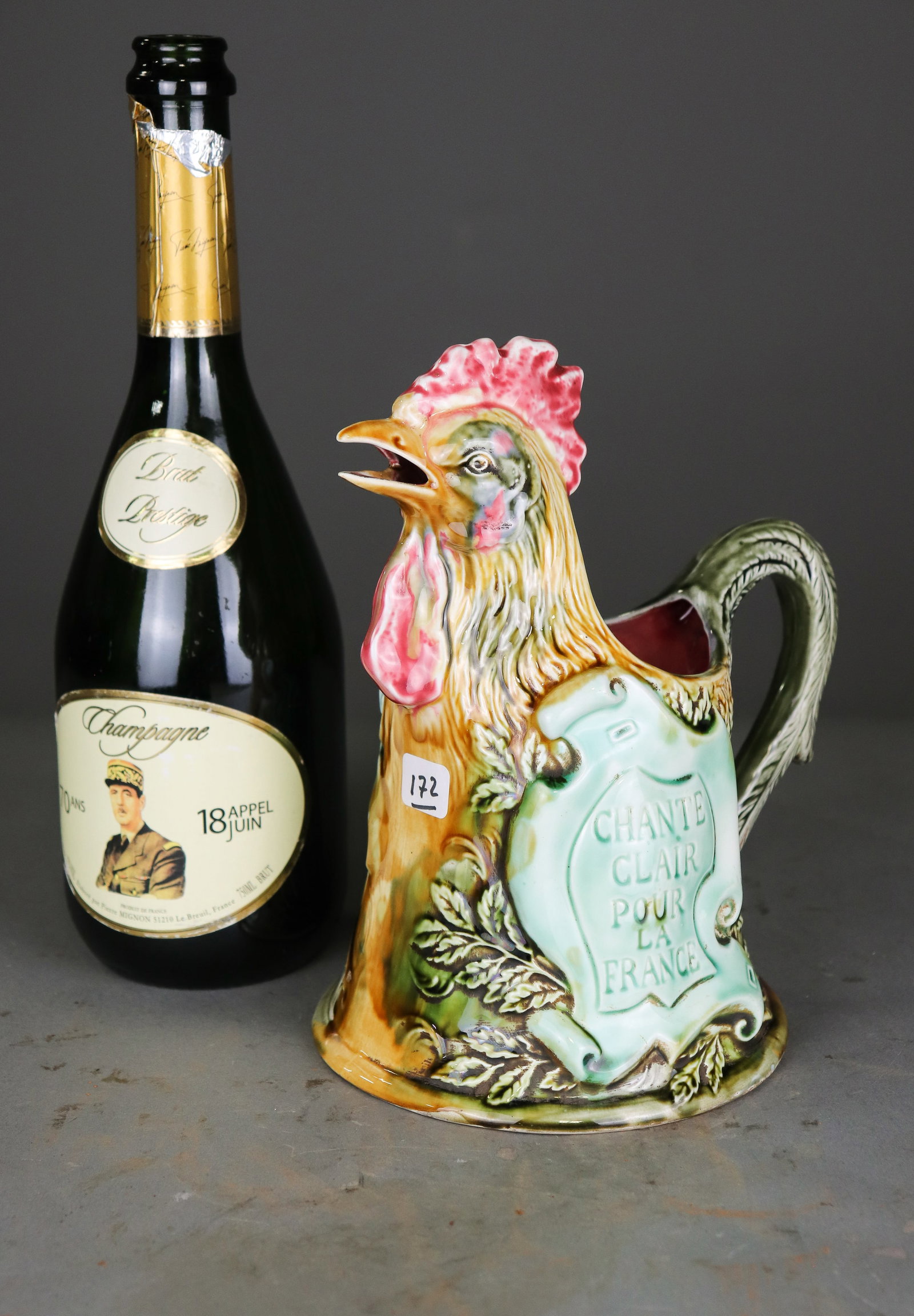 French Onnaing Majolica Le Gaulois Rooster Pitcher No. 658: French Onnaing majolica figural pitcher modeled as a colorful rooster with "Le Gaulois" and "Chante Clair Pour La France" molded decoration. Marked Onnaing France and numbered 658 on the underside. - 