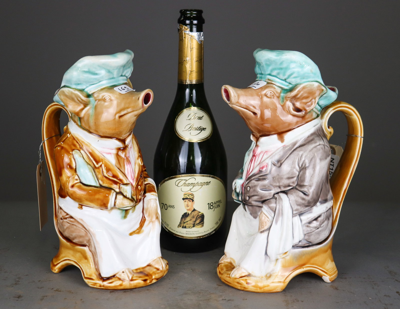 Pair French Onnaing Majolica Figural Pig Pitchers No. 737: Pair of French Onnaing majolica figural pitchers modeled as whimsical dressed pigs wearing turquoise caps. Colorfully glazed in two different colorways. Both marked Onnaing and numbered 737, Made in F