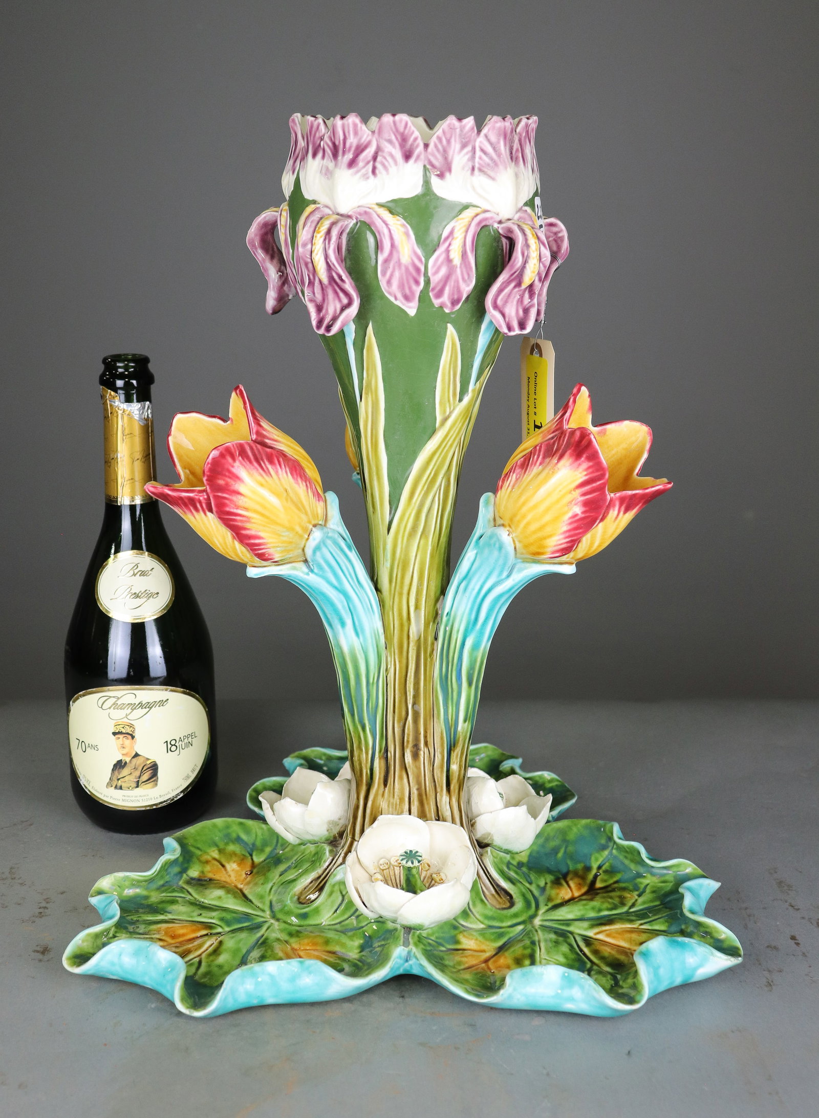 Large Majolica Iris & Floral Figural Centerpiece Vase: Large colorful majolica centerpiece vase modeled with iris and other flowering blooms rising above a naturalistic lily pad base. Bold sculptural form with vibrant multicolor glazes. Turquoise glazed u