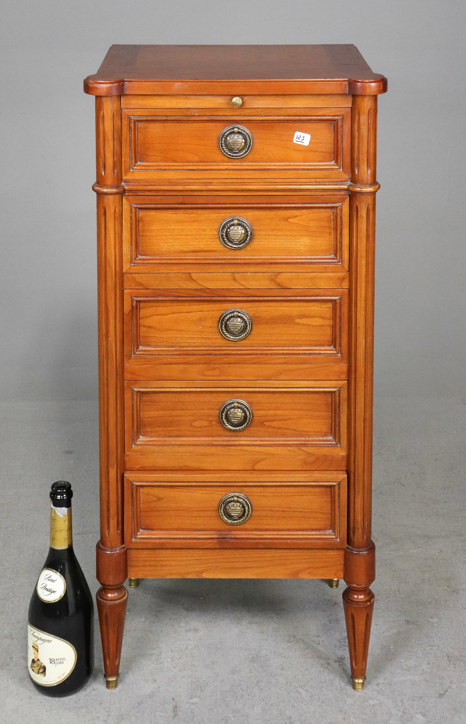 French Louis XVI Style Five Drawer Nightstand with Pull-Out Shelf: French Louis XVI style tall bedside cabinet or nightstand featuring five drawers, a pull-out writing or serving shelf, paneled sides, fluted corner columns, brass ring pulls and tapered legs with bras