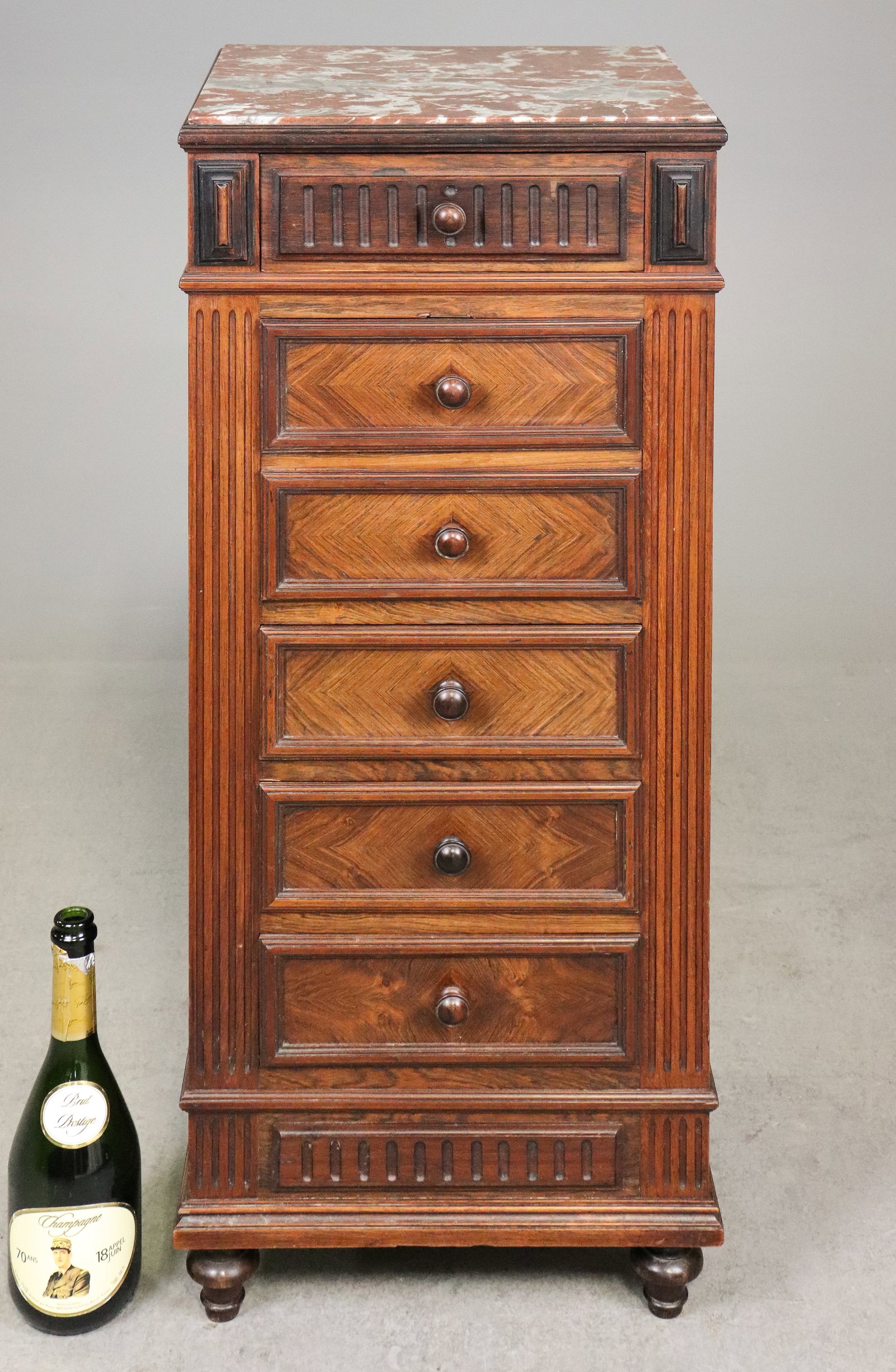 French Marble Lined Bedside Cabinet with Drawers: French bedside cabinet or nightstand featuring a dark wood case with architectural fluted detailing, decorative geometric inlay, upper and lower drawers, and an open marble-lined compartment with pull