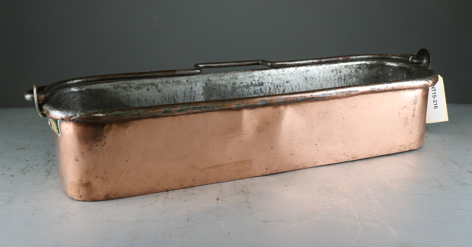 Large Stamped French Copper Fish Poacher with Iron Handle: Large antique French copper fish poacher with elongated oval-form body, tinned interior and substantial iron swing handle. Classic French culinary cookware with an attractive aged copper patina. - sta