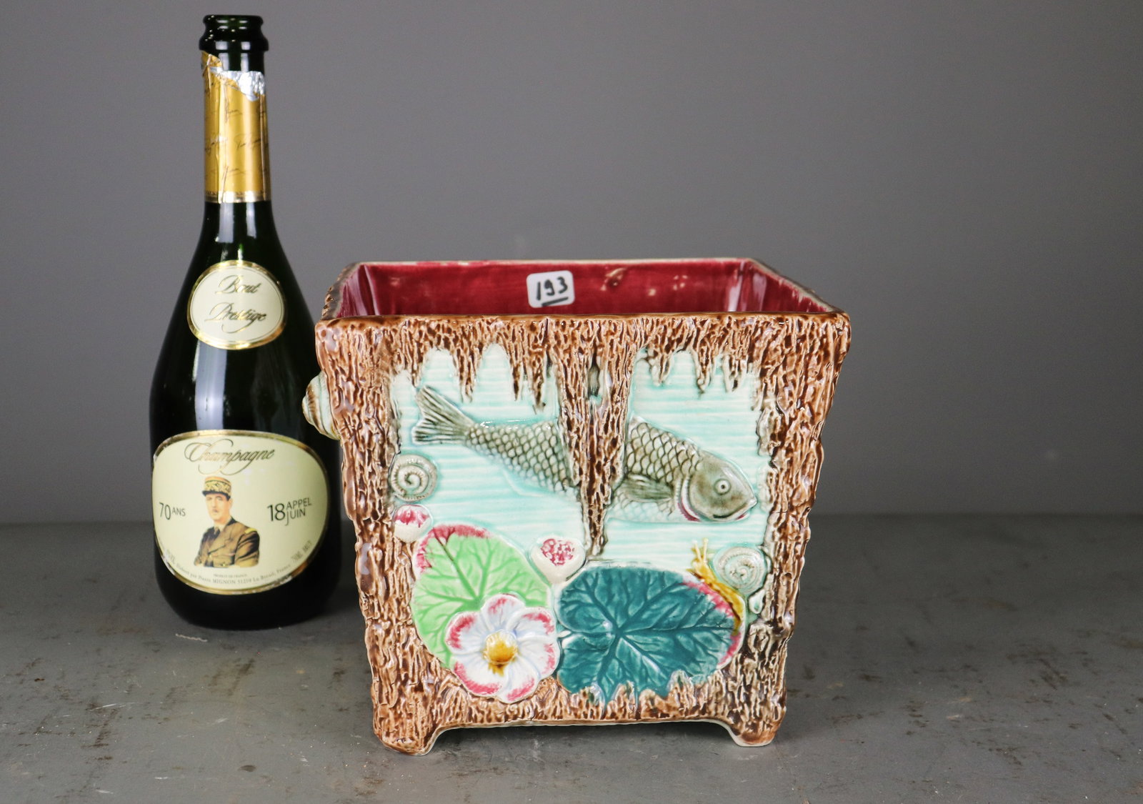 Majolica Fish & Snail Aquatic Jardiniere Planter: Colorful glazed majolica jardiniere featuring an unusual aquatic motif with raised fish, snails, lily pads and flowers against a turquoise ground. Textured brown borders resemble a rustic grotto or dr