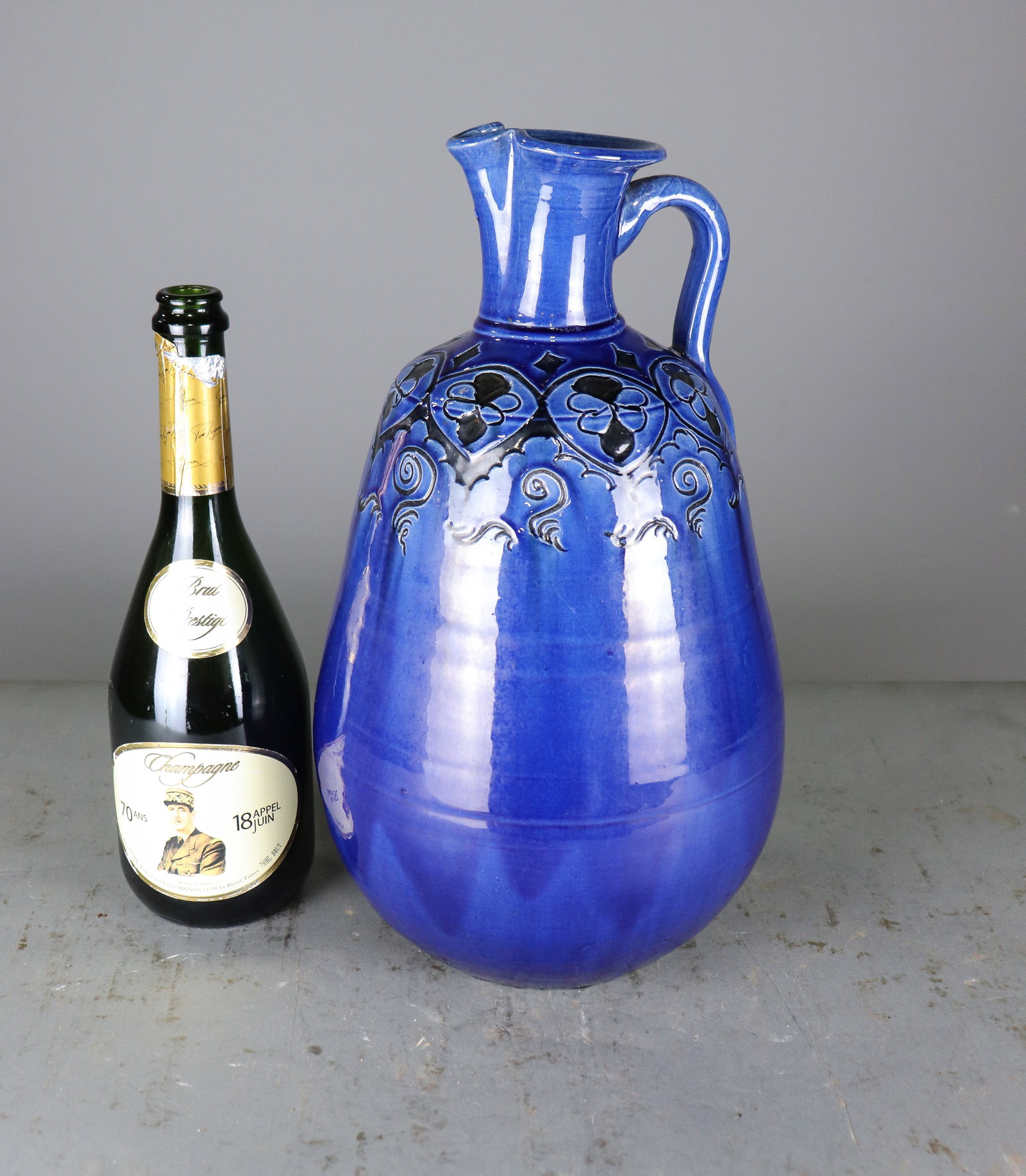 Gongora Mexico Cobalt Blue Glazed Pottery Pitcher: Large Mexican pottery pitcher by Gongora, finished in a rich cobalt blue glaze with raised floral and scrolling decoration around the shoulder. Applied handle and flared spout. Signed "Gongora Mexico"
