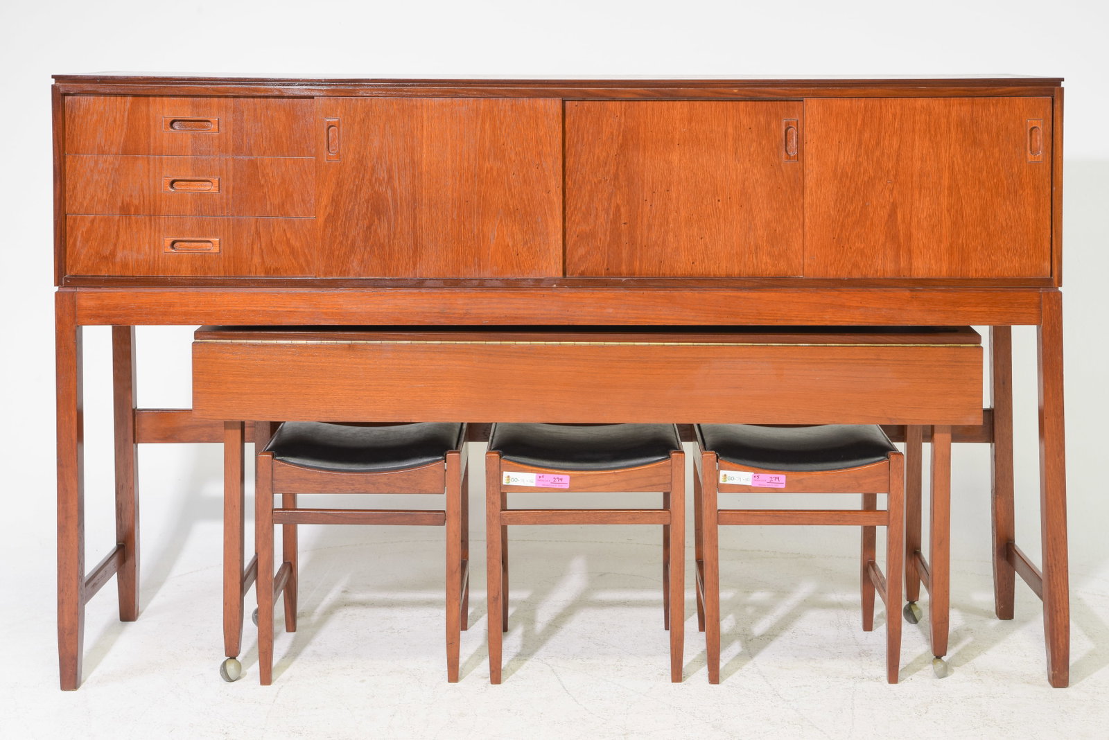 Arthur Edwards for White & Newton Space-Saving Dining Suite: Rare British Mid Century Modern space-saving dining suite designed by Arthur Edwards for White & Newton of Portsmouth, circa 1958. Ingenious all-in-one design comprising a raised sideboard /