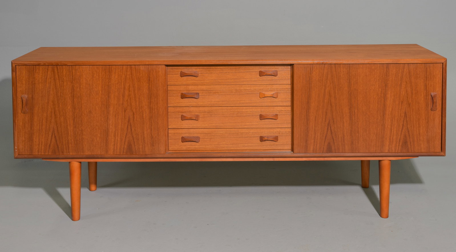 Danish Modern Sideboard - Clausen & Son: This Mid Century Modern Credenza is by Clausen & Son , it features bow tie shaped handles, two sliding doors & a bank of 4 drawers to the middle - 31.5 in tall x 82 x 18