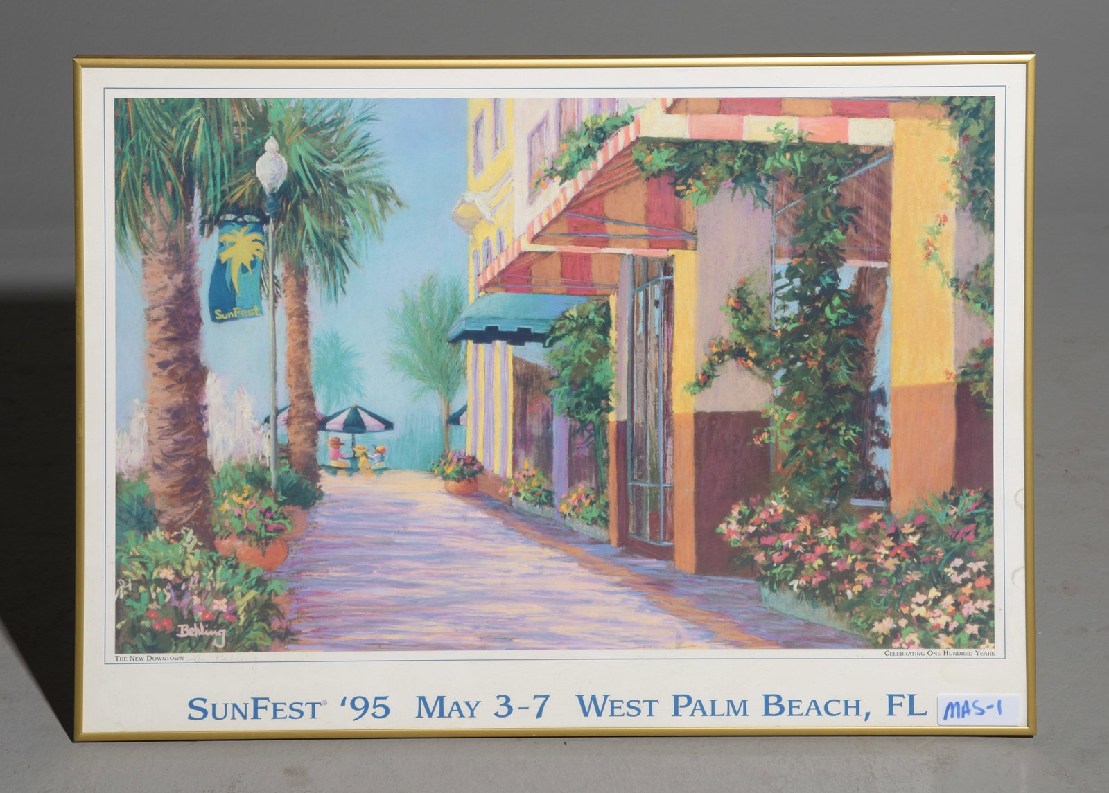 Kim Behling Framed SunFest Poster: Kim Behling Framed SunFest Poster depicting a sunlit Florida street scene with palm trees and Mediterranean architecture - 22.5 in tall x 31 x 1