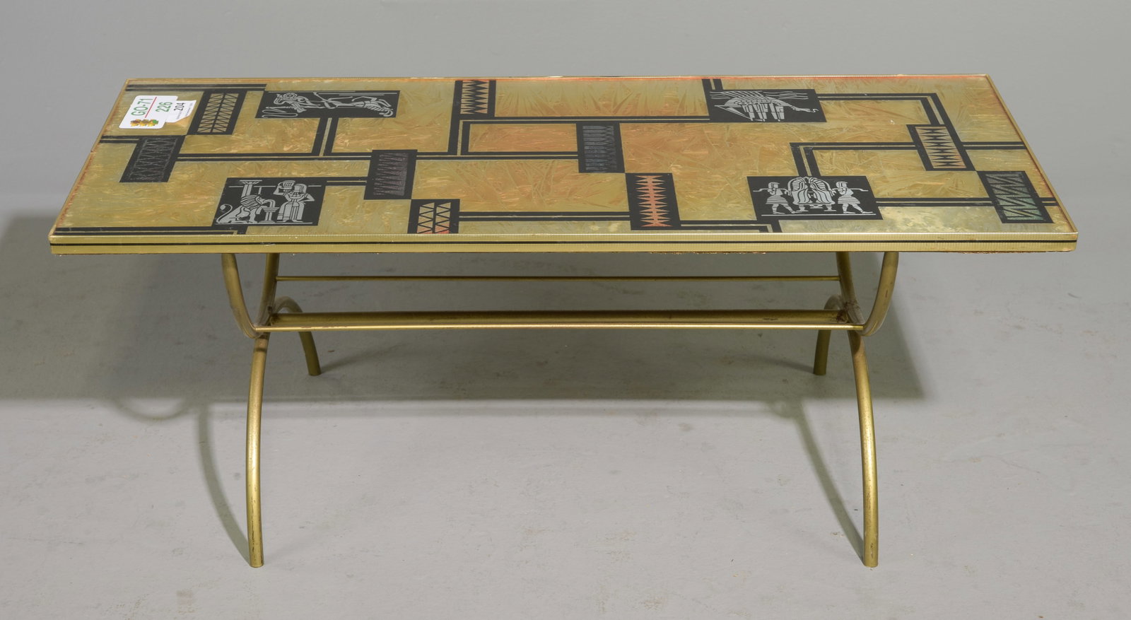Denmor of London Style Mid Century Coffee Table: Denmor of London Style Mid Century Coffee Table featuring a gold tubular metal base with a neo-Egyptian glass top - 16.5 in tall x 41.5 x 17.5