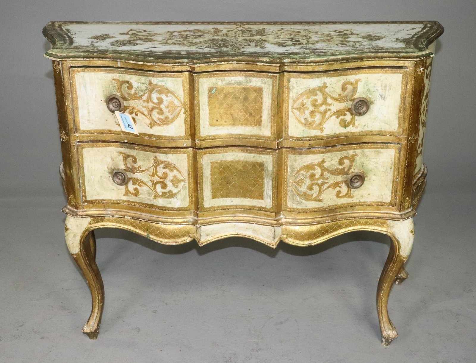 Italian Florentine Style Gilt Painted Bombe Commode: Italian Florentine style painted and gilt bombe commode featuring a shaped top over four drawers arranged in two rows. Serpentine case with scrolling foliate decoration, gilt borders and decorative si
